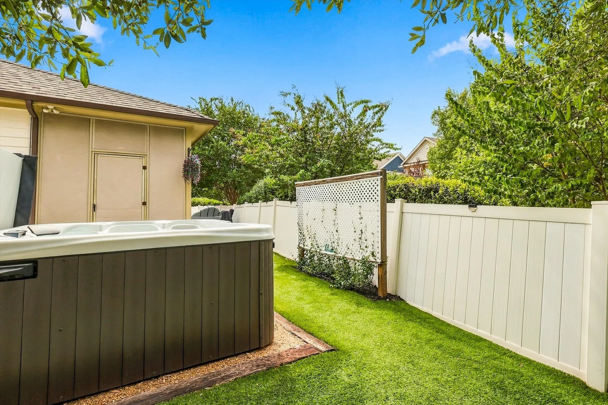 A stretch of turf beside the hot tub adds usable outdoor space with less mowing to do.