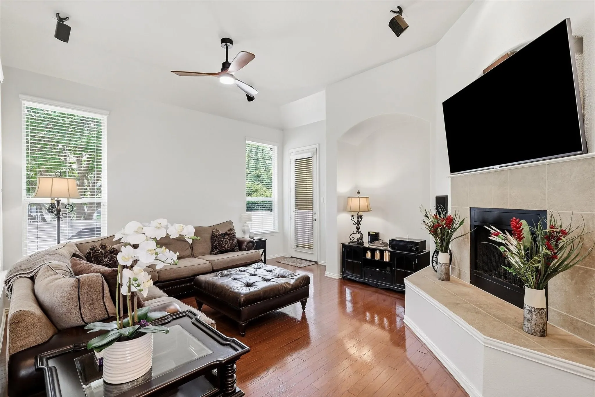 Settle into the welcoming family room, where wood flooring, natural light, and a gas fireplace create a comfortable retreat.