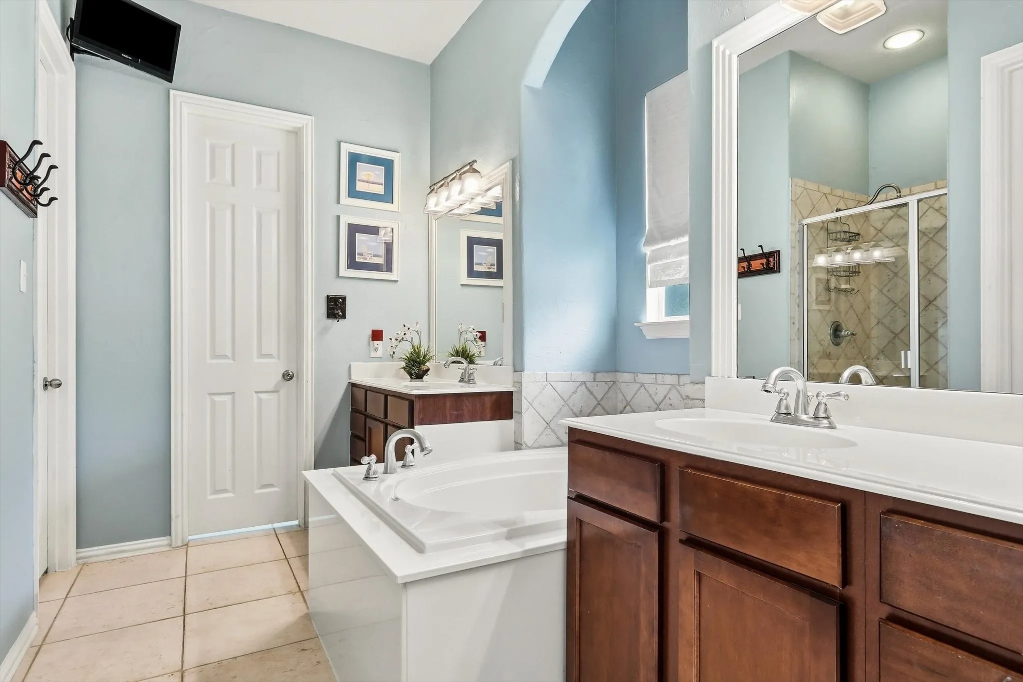 Separate vanities and a soaking tub offer space to get ready comfortably or unwind at the end of the day.