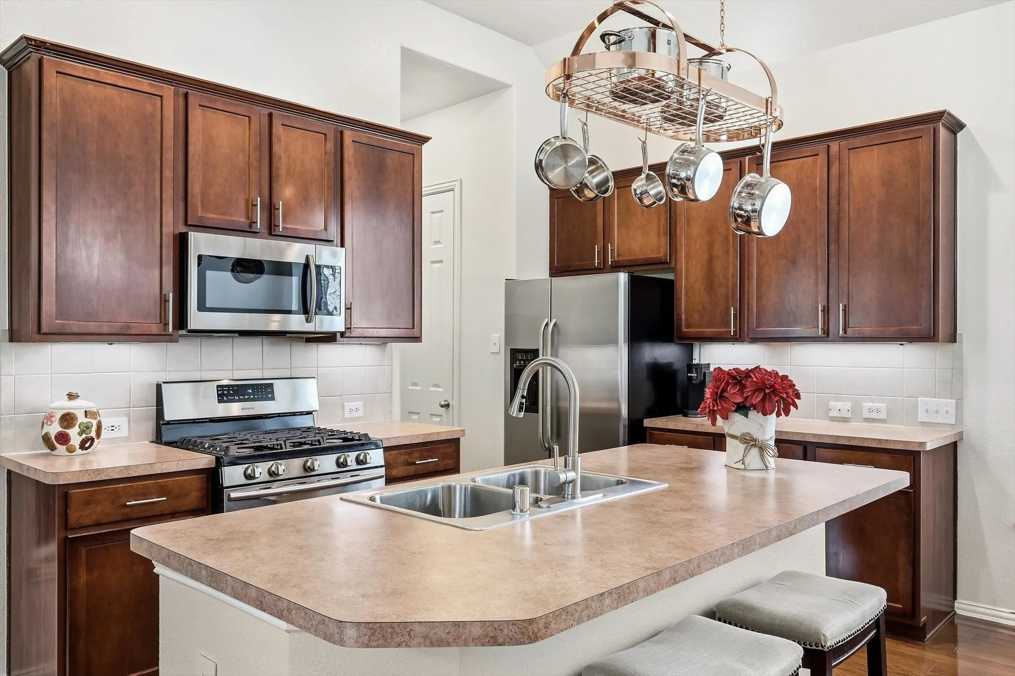 The heart of the home features 42-inch cabinetry, stainless steel appliances, gas cooking, and island seating.
