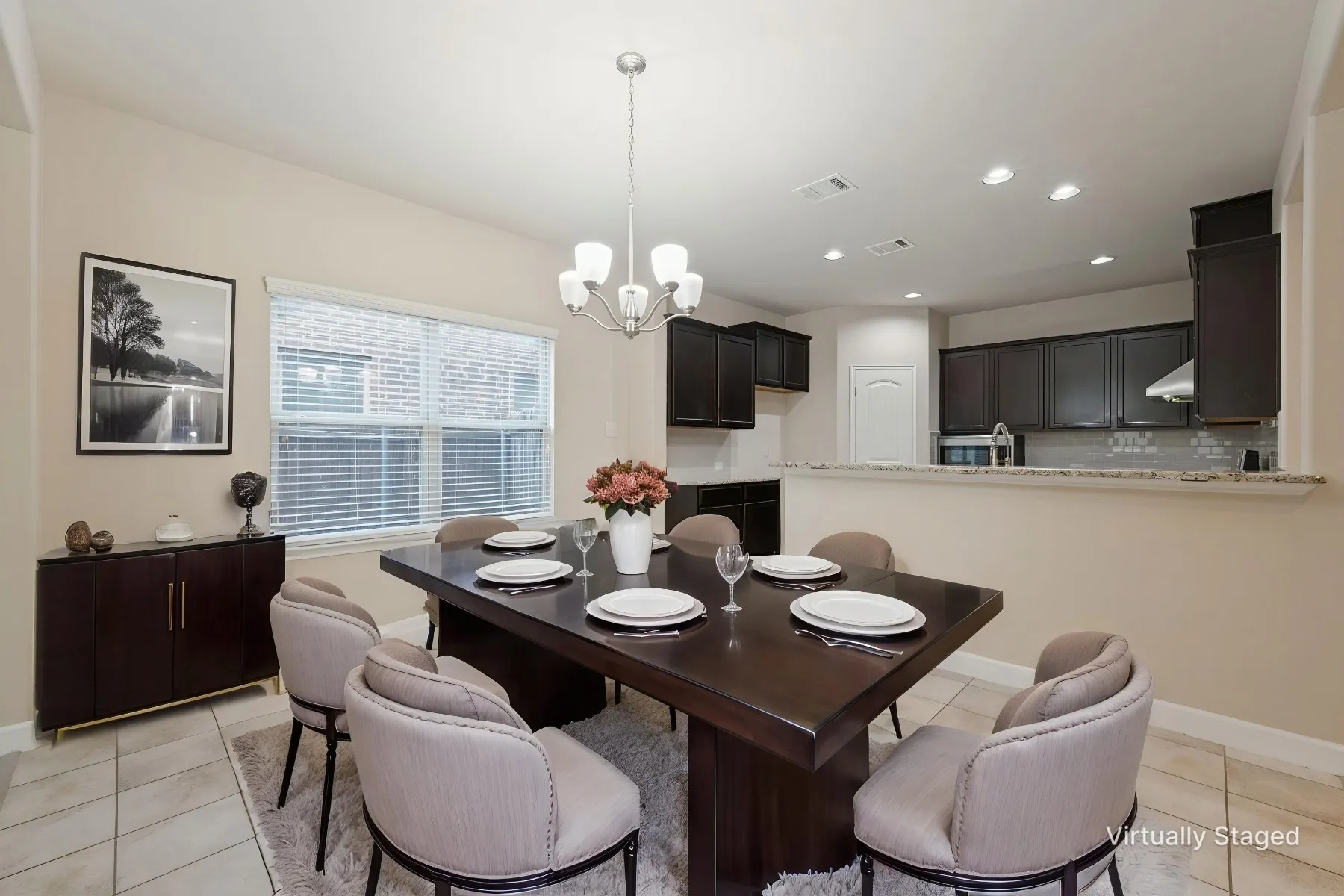 Recessed lighting, tiled flooring, built-in cabinetry, and a kitchen pass-through with a stone-finish countertop