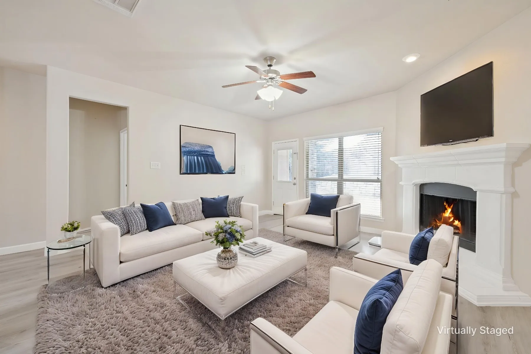 Living area featuring a fireplace with a white mantel, ceiling fan, recessed lighting, and wood-finish flooring