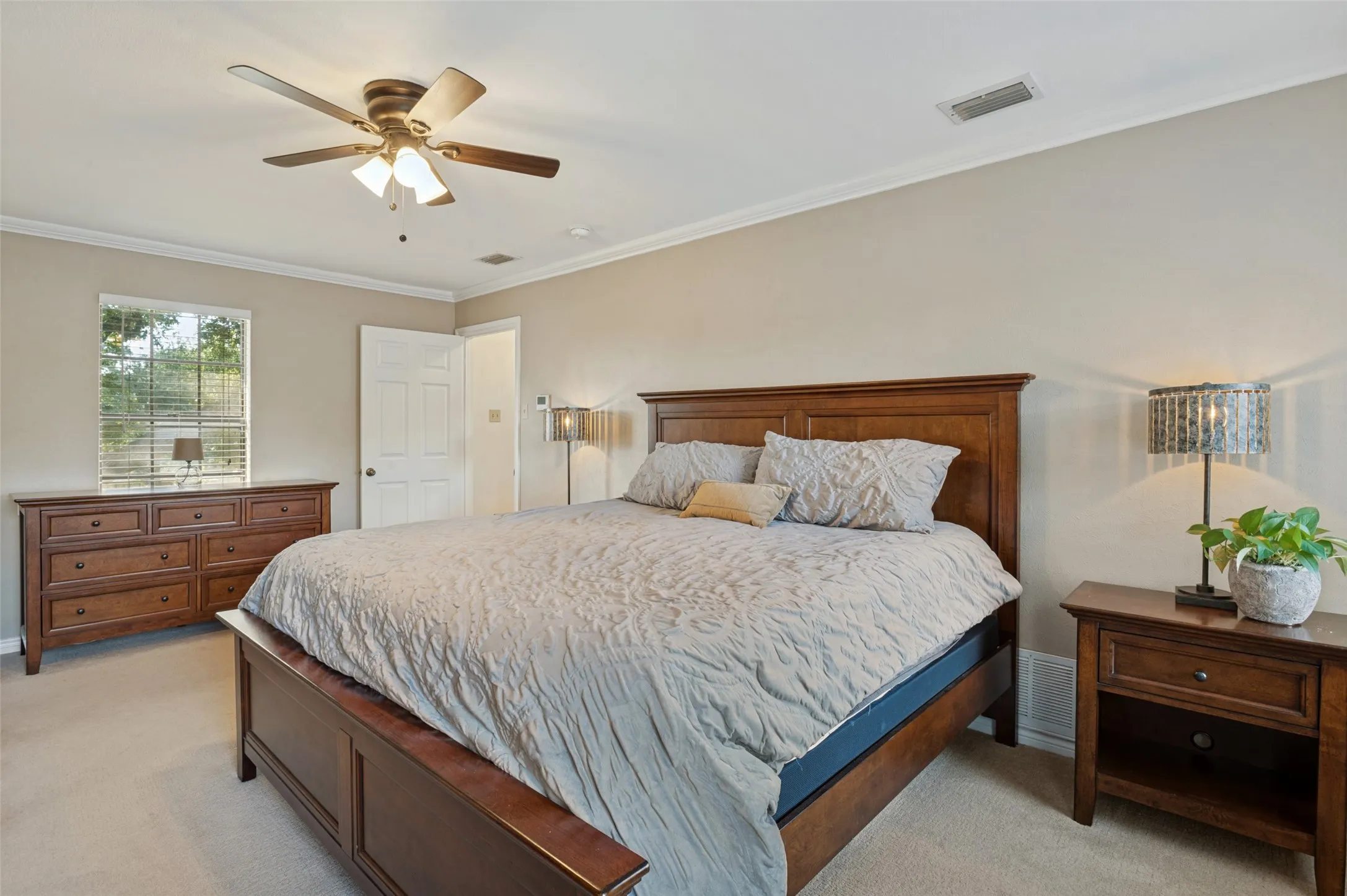 Recessed lighting with a ceiling fan, crown molding, and neutral wall paint