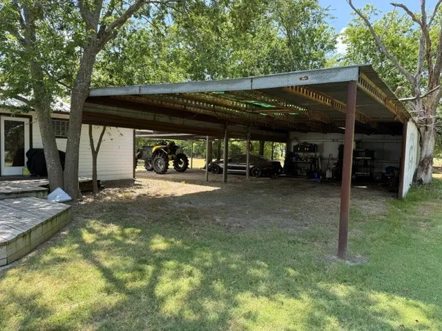 Covered structure with a metal roof and support beams