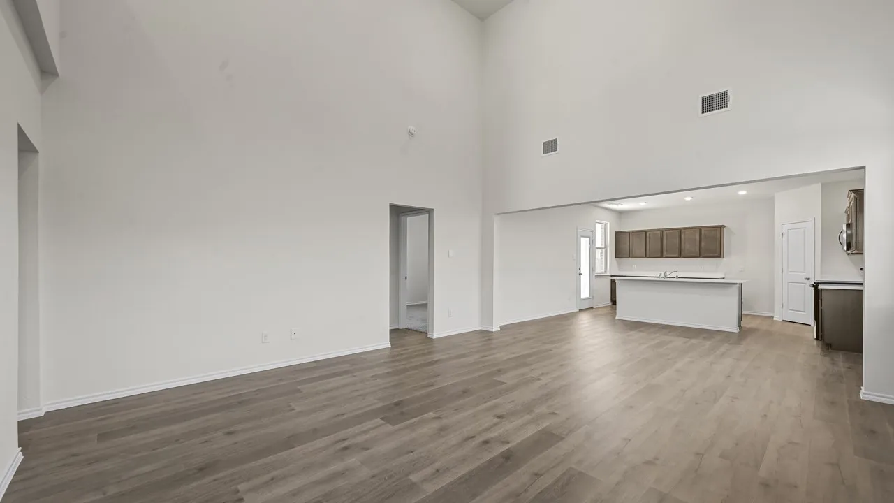 Soaring ceilings, wood-finish flooring, and an open-concept layout