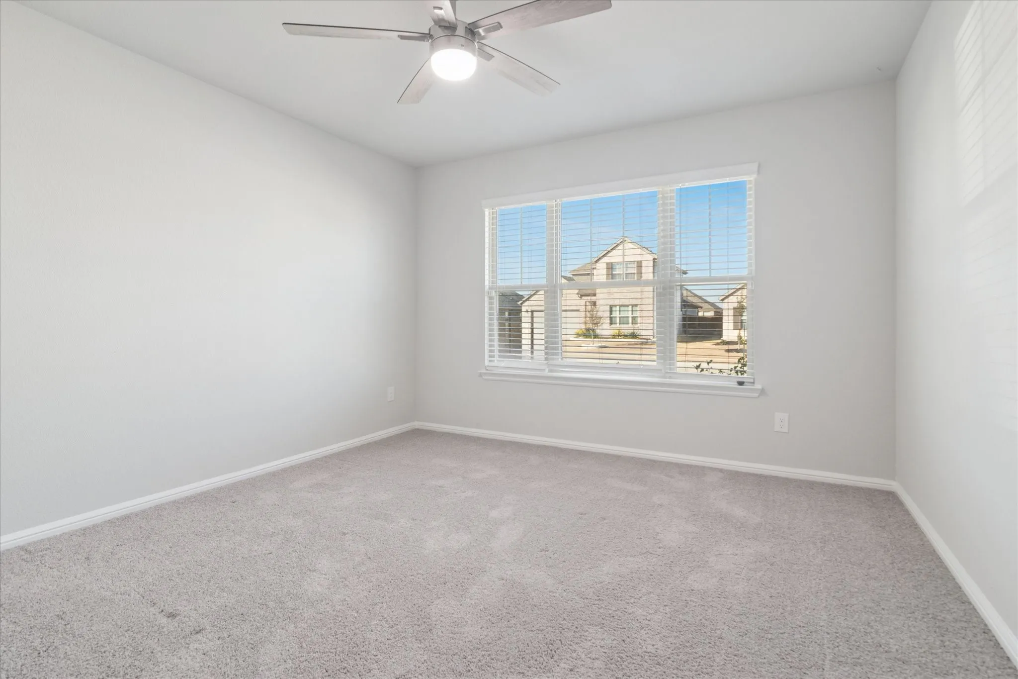 Recessed lighting, ceiling fan fixture, large window, window blinds, and carpeted flooring