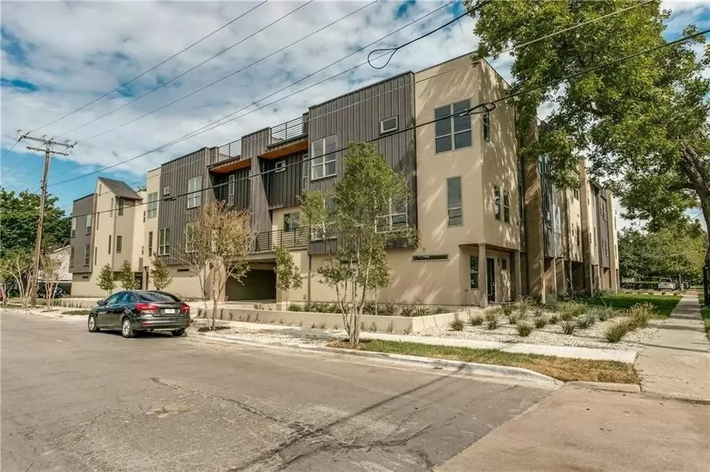 Contemporary multi-story architecture with a combination of stucco and vertical panel siding