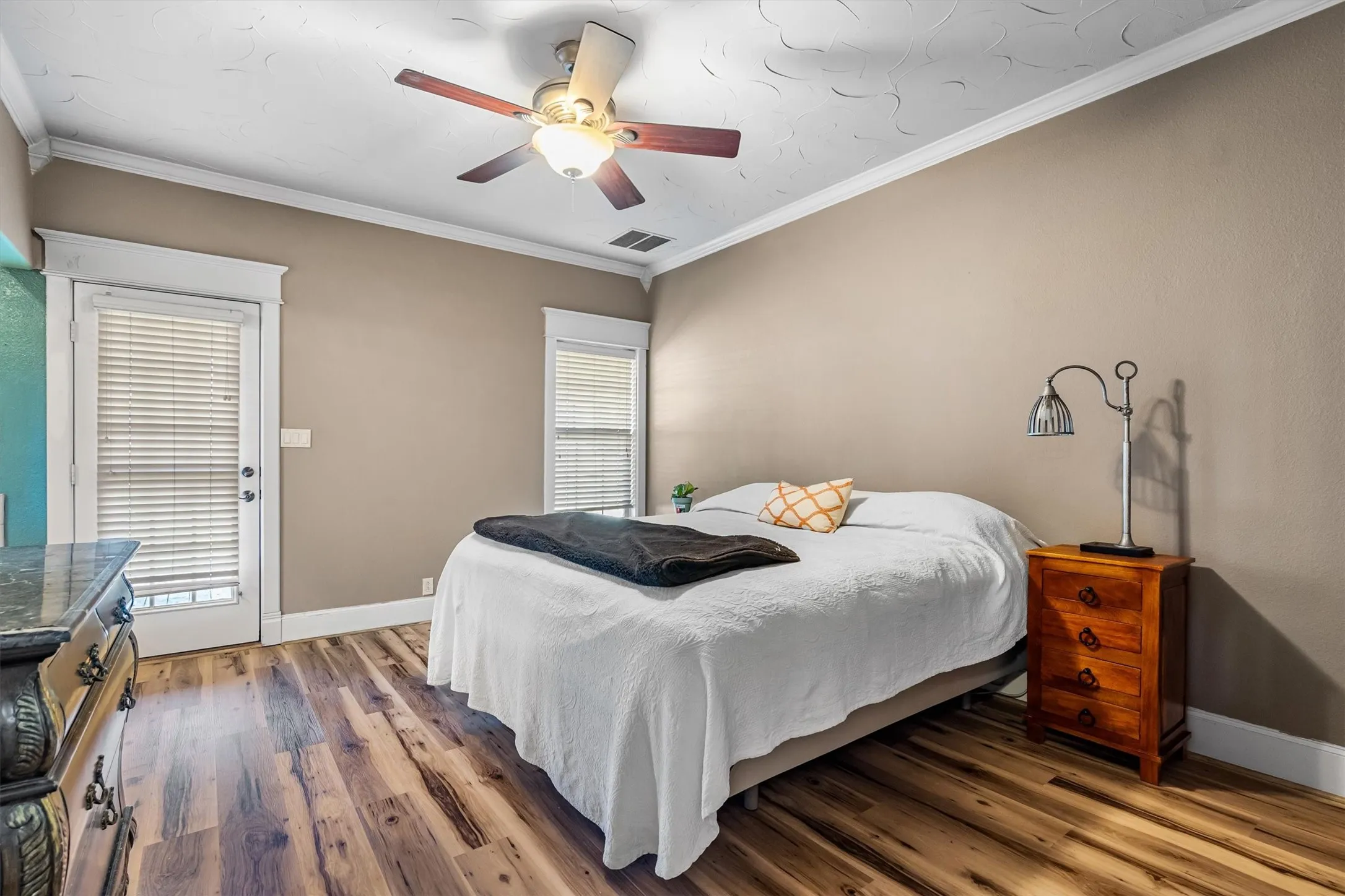 Large primary bedroom that has an entrance to the backyard