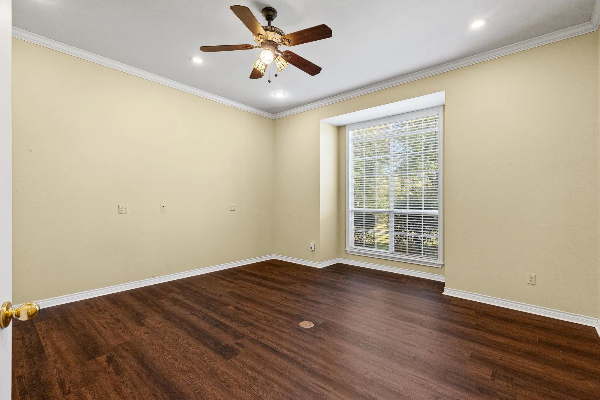 Office on main floor is spacious, with window nook and high ceilings.