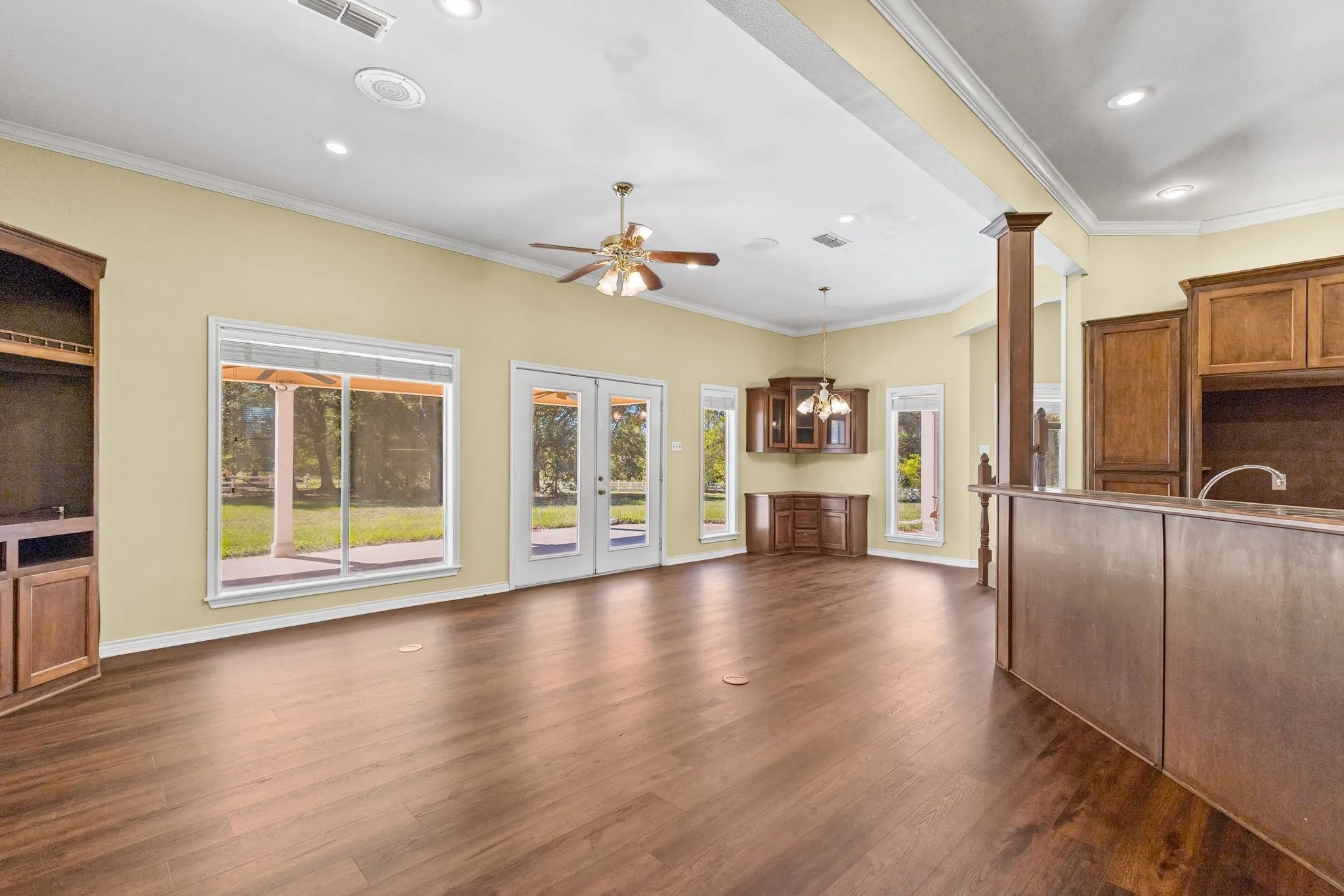 Great room is next to the kitchen, includes a breakfast nook with built-in cabinets.  Kitchen island has breakfast bar