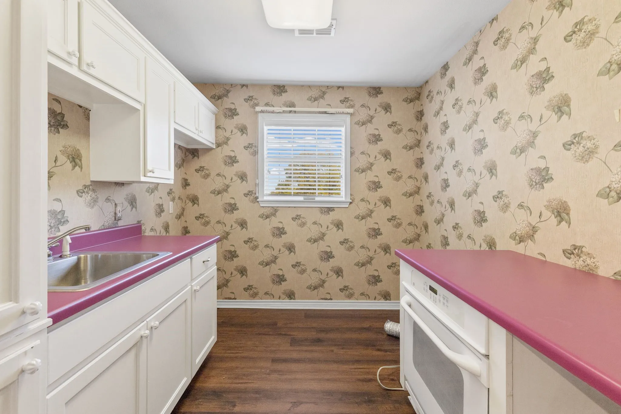 Utility room is between garage and kitchen, features sink, warming oven for entertaining, space for freezer, washer, dryer.