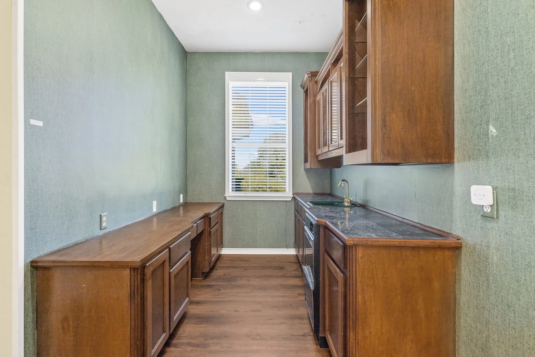 Directly off the kitchen is a wet bar with sink and ice maker.