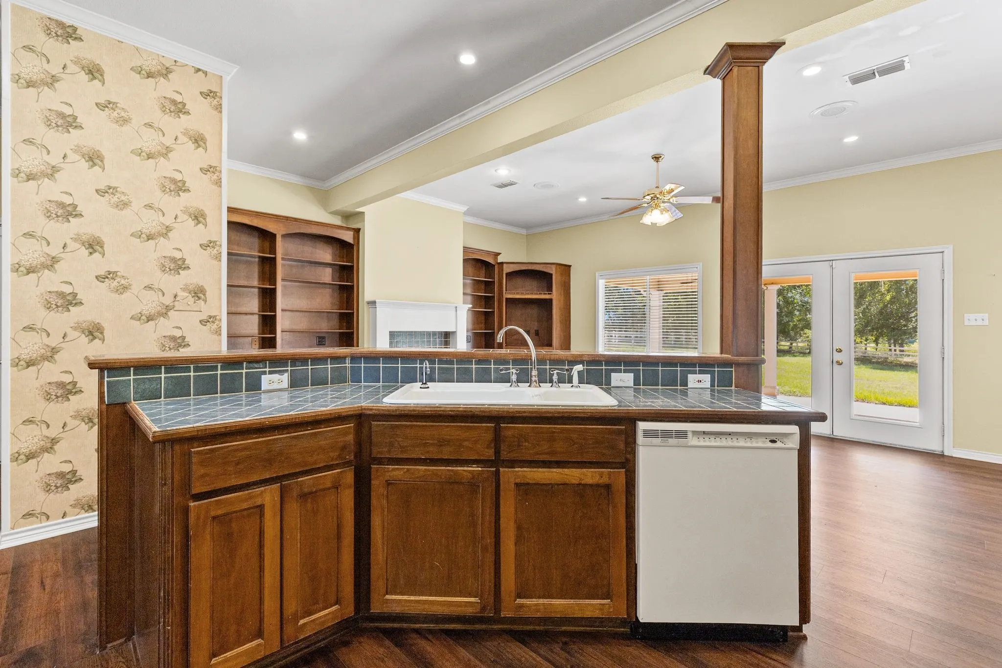 Kitchen has island with breakfast bar, view of the great room and back porch.