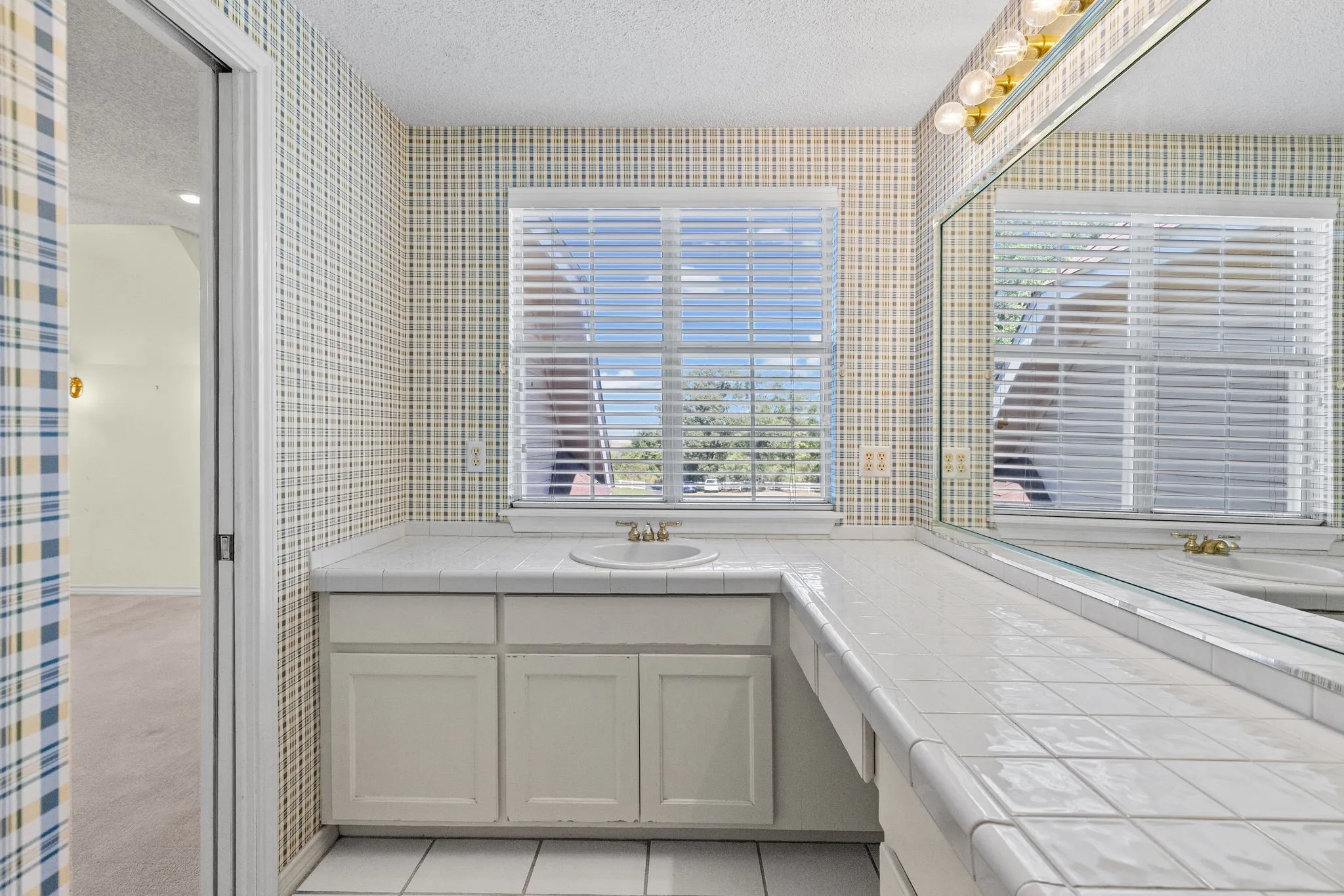 Ensuite bath for bedroom 4 has large vanity, walk-in shower.