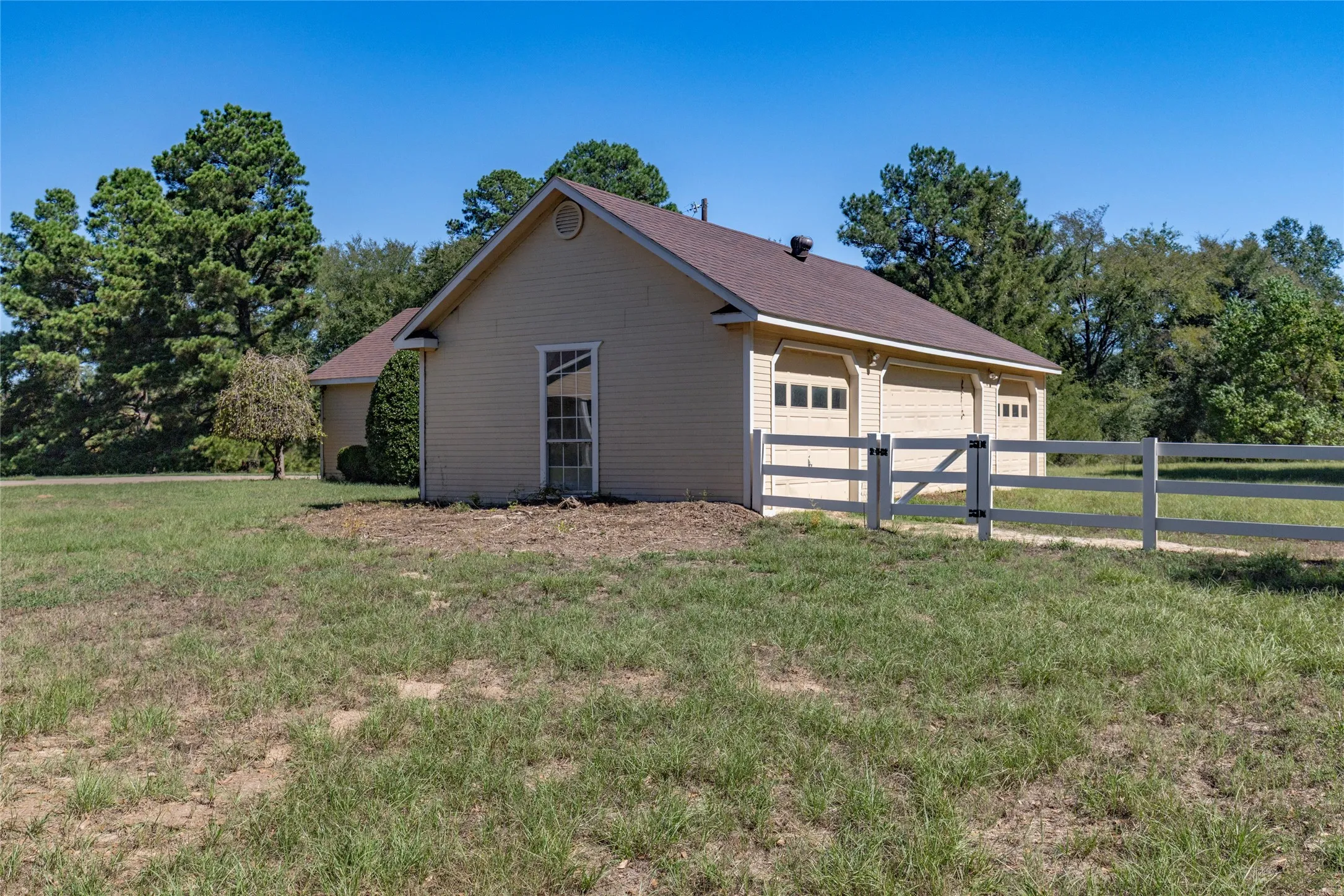 Backside of workshop can double as barn and is separately fenced for animals.