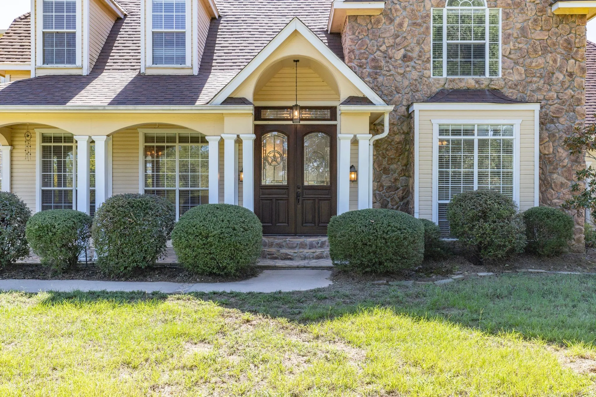 stunning stone and wood home; 5000+ sq ft, 5 bedrooms, 4.5 baths, 3 living areas, 3- car garage, sweeping porches with beautiful pasture views