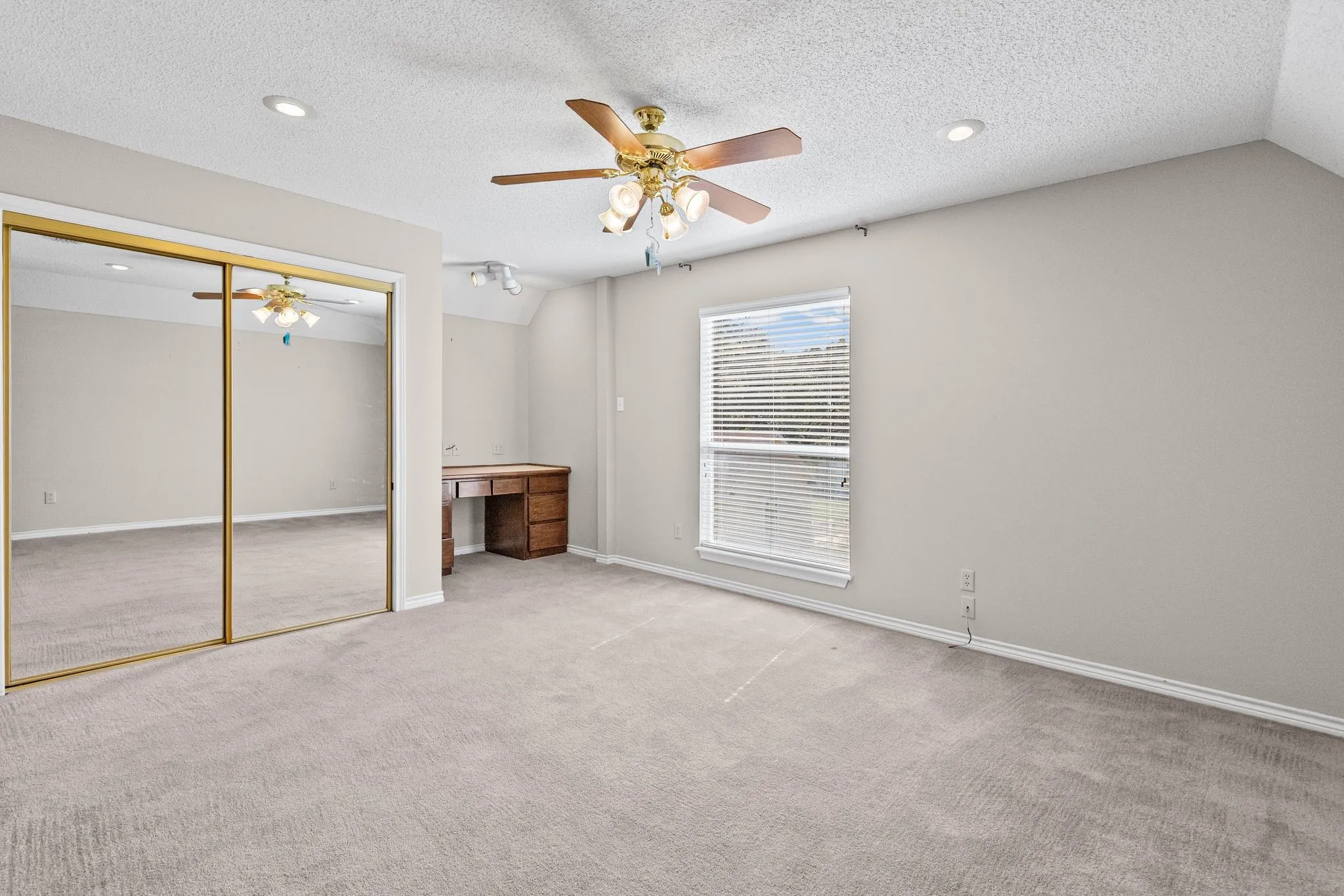 Bedroom 3 is the other bedroom tucked behind the game room, with built-in desk and WIC.