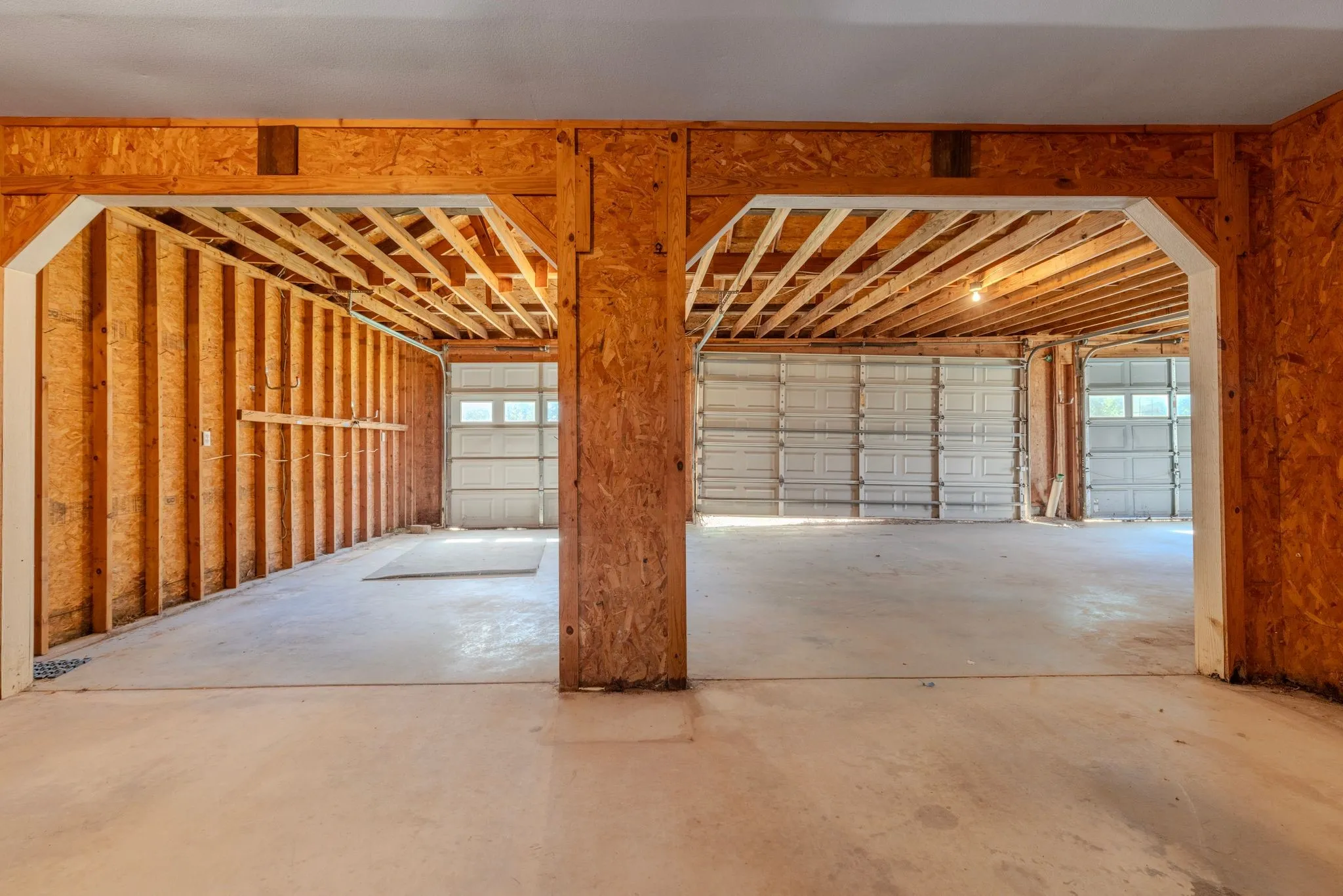 HUGE workshop has approx 2000 sf, 6 garage doors, central room, electricity, floored attic.