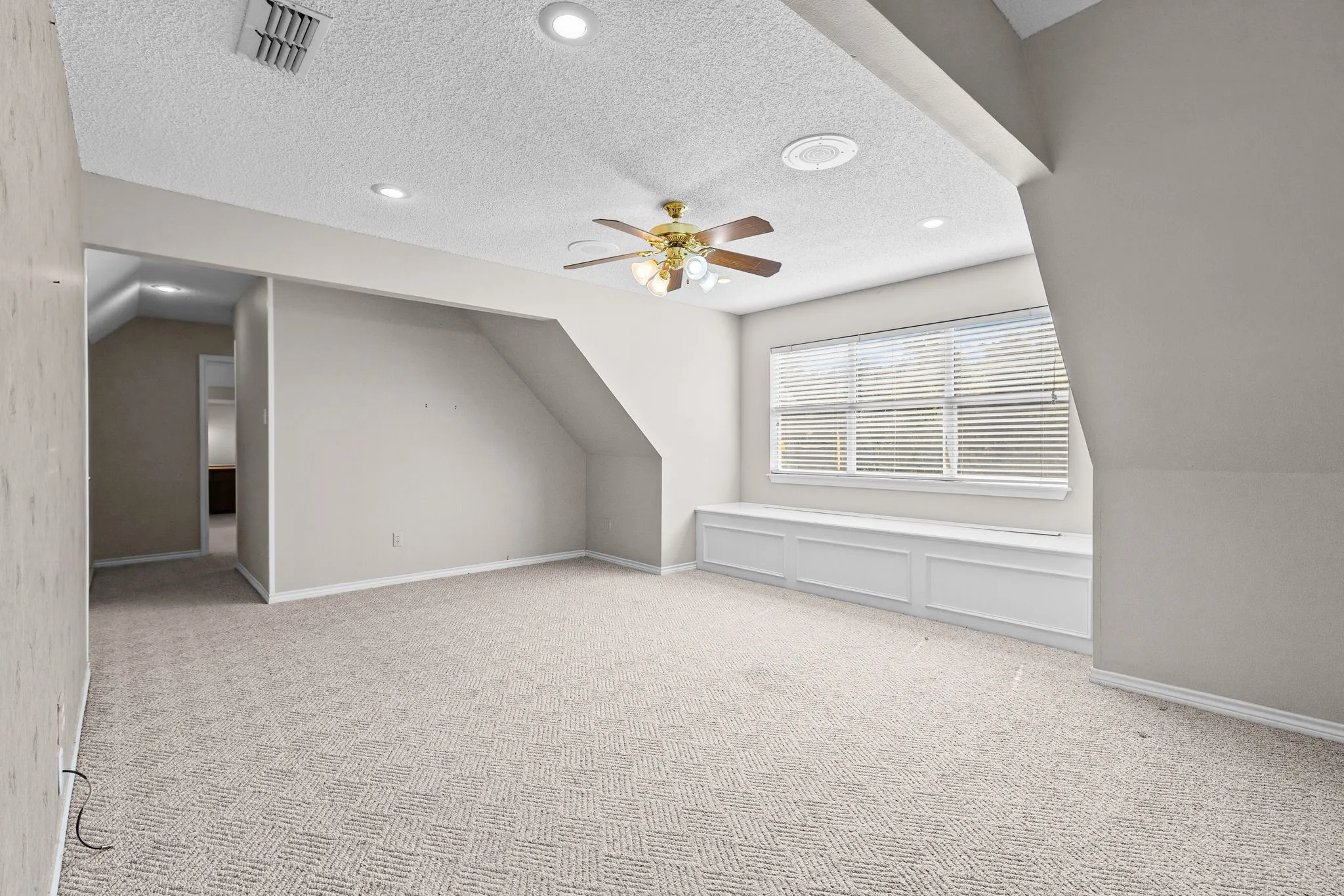 Upstairs, there is a large bonus or game room, with window seat with storage.  Hall leads back to two hidden bedrooms and a shared bath.