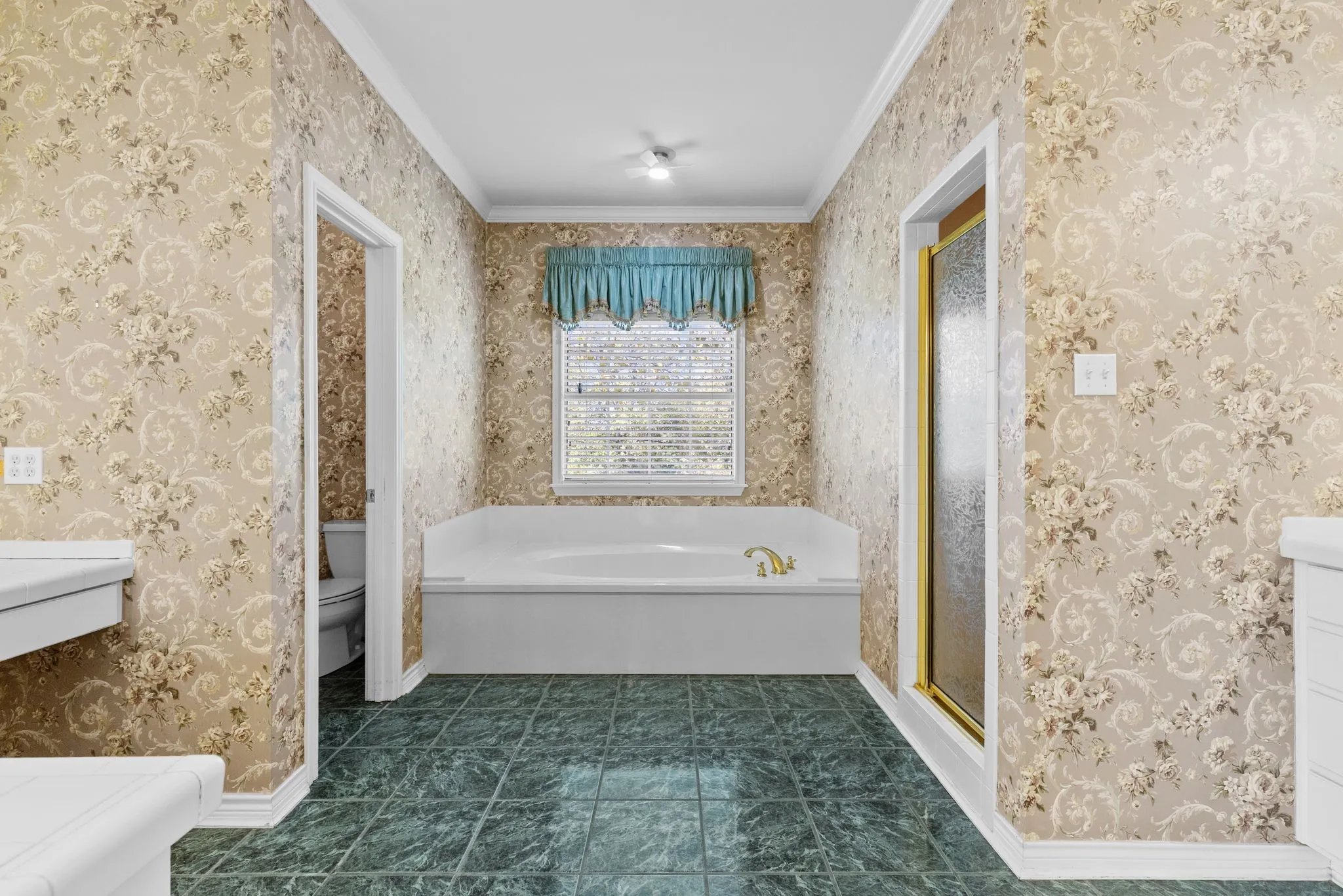 Primary bathroom has soaking tub and separate shower, private potty and separate vanities.