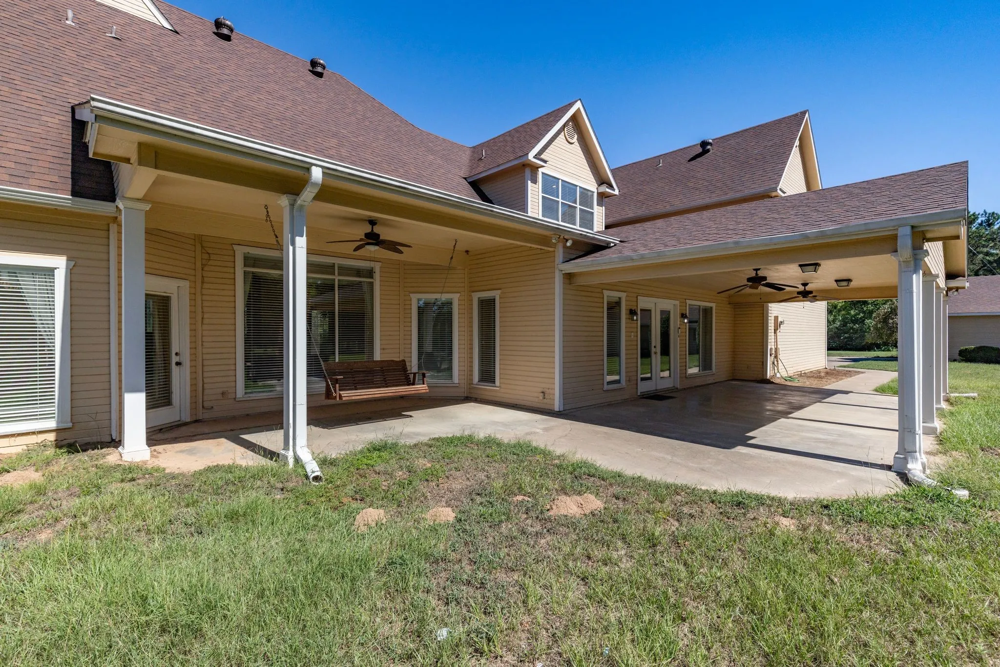 A view of the main back porch, and the private back porch outside the primary suite.