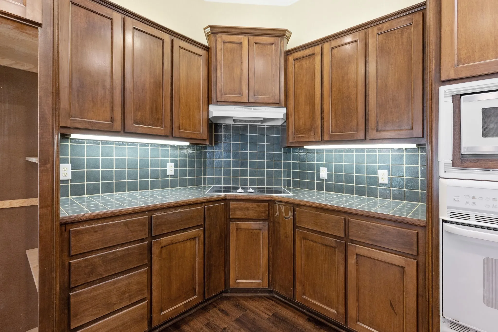 Kitchen has good work triangle, lots of storage, custom wood cabinets.