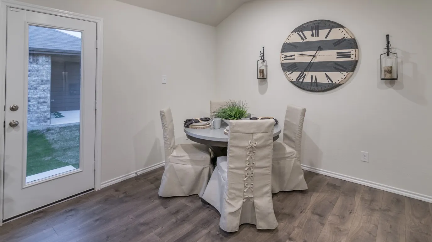 Hardwood-finish flooring complementing light wall tones and white baseboards