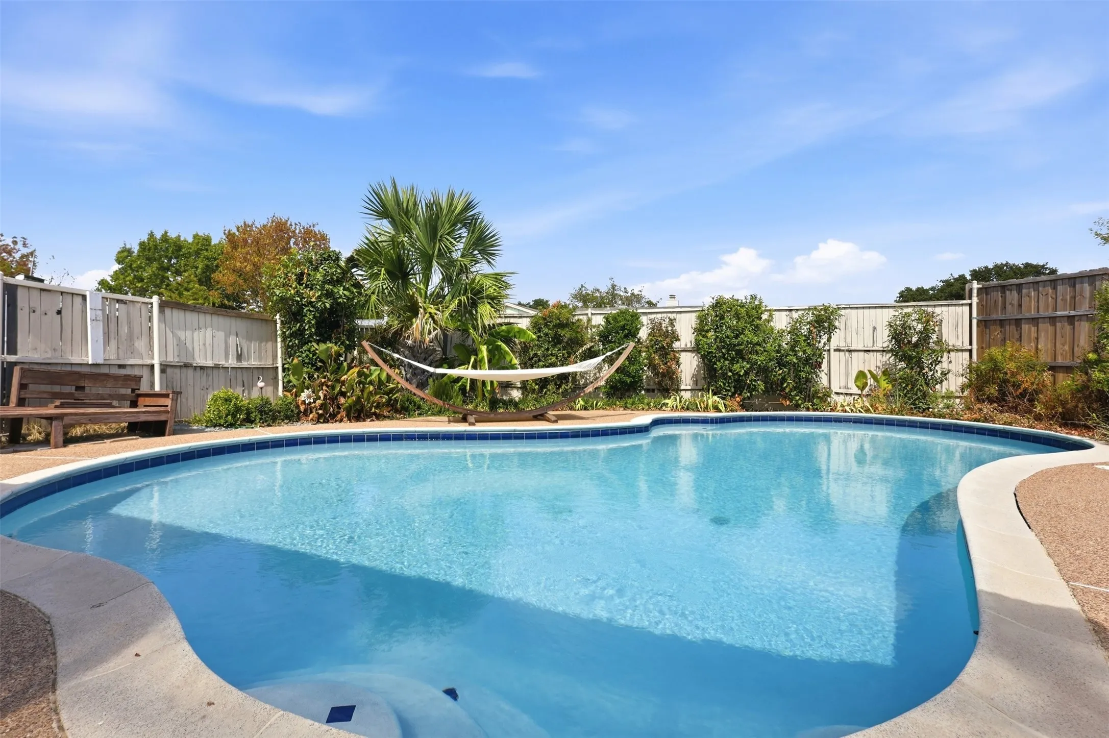 Resort-style backyard setting featuring the refreshed pool and spacious surrounding deck.