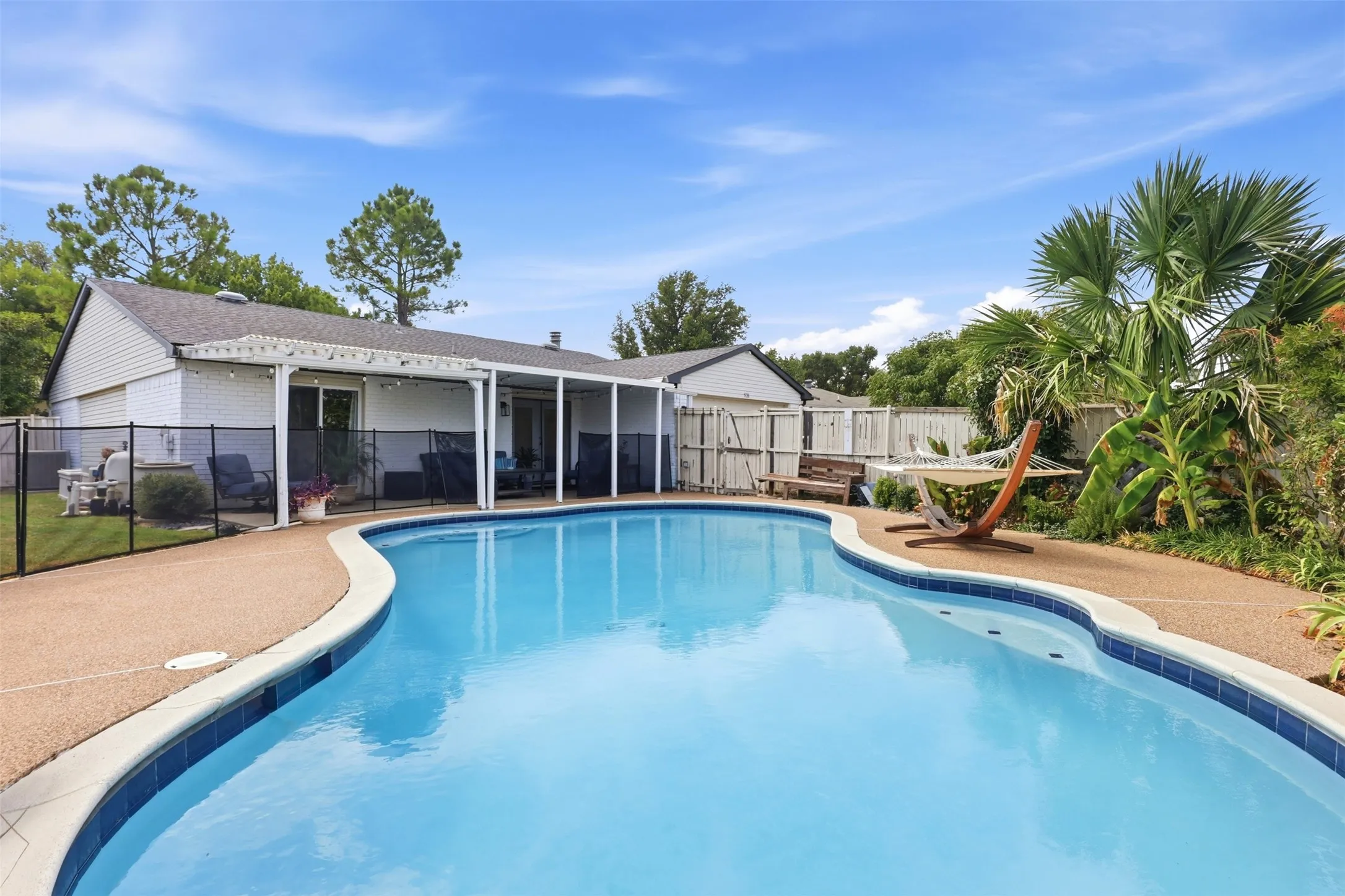 Beautiful pool and deck area with plenty of space for lounging, entertaining, and summer fun.