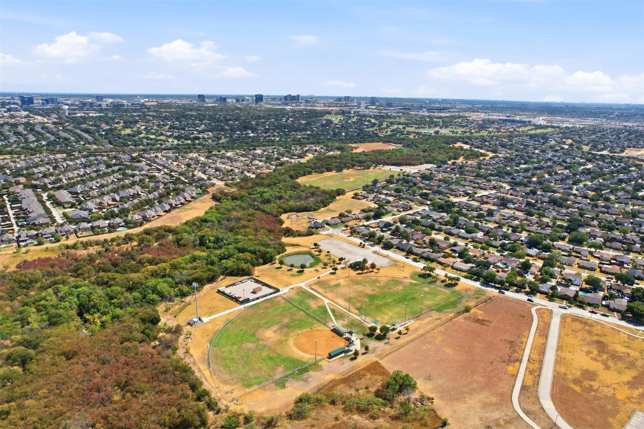 Wide aerial view showing the home’s central location with easy access to nearby amenities and major transportation routes.