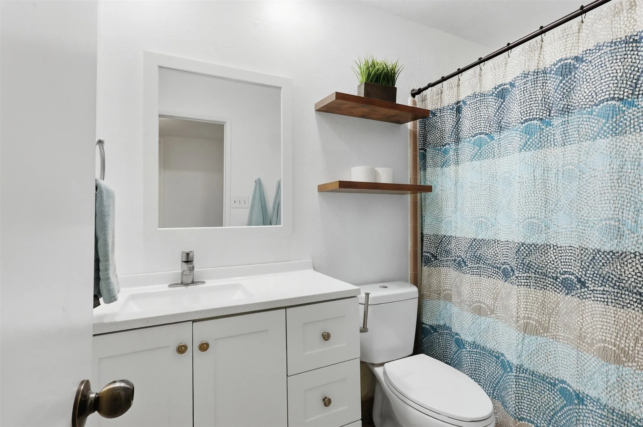 full secondary bath with a bright vanity area and tub/shower combination.