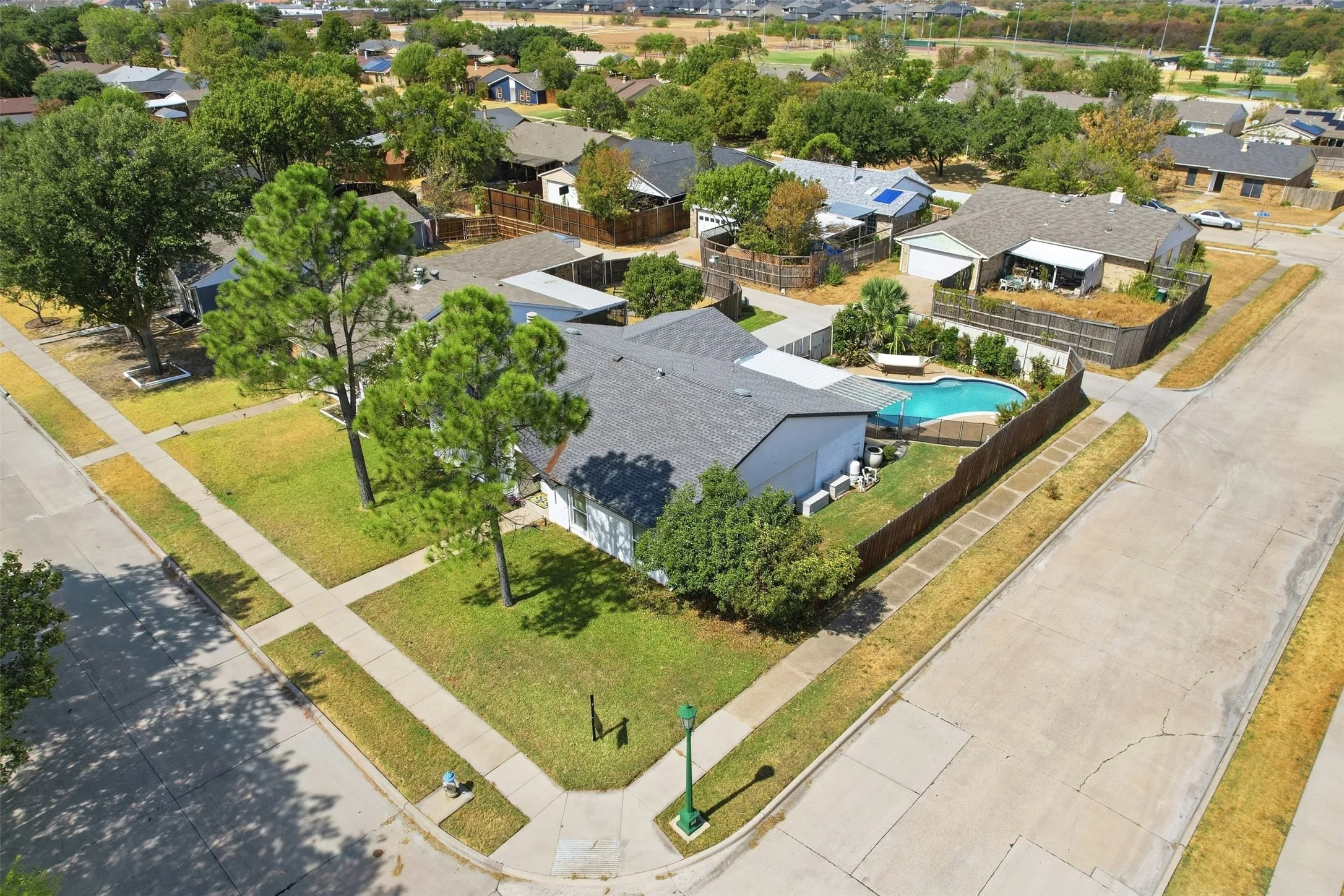 Aerial view highlighting the home’s desirable corner-lot setting and surrounding neighborhood.