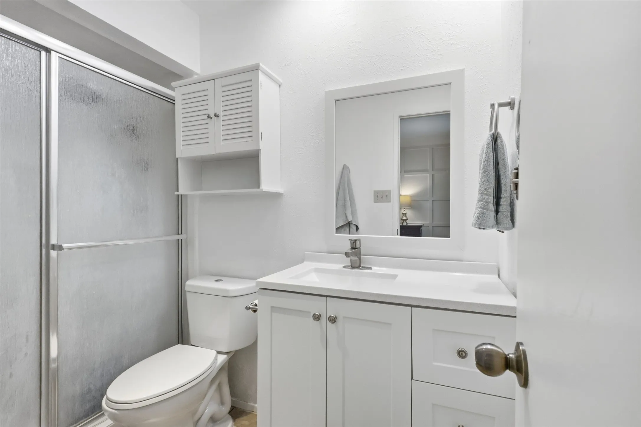 Clean and bright primary bath with updated finishes and plenty of vanity storage.
