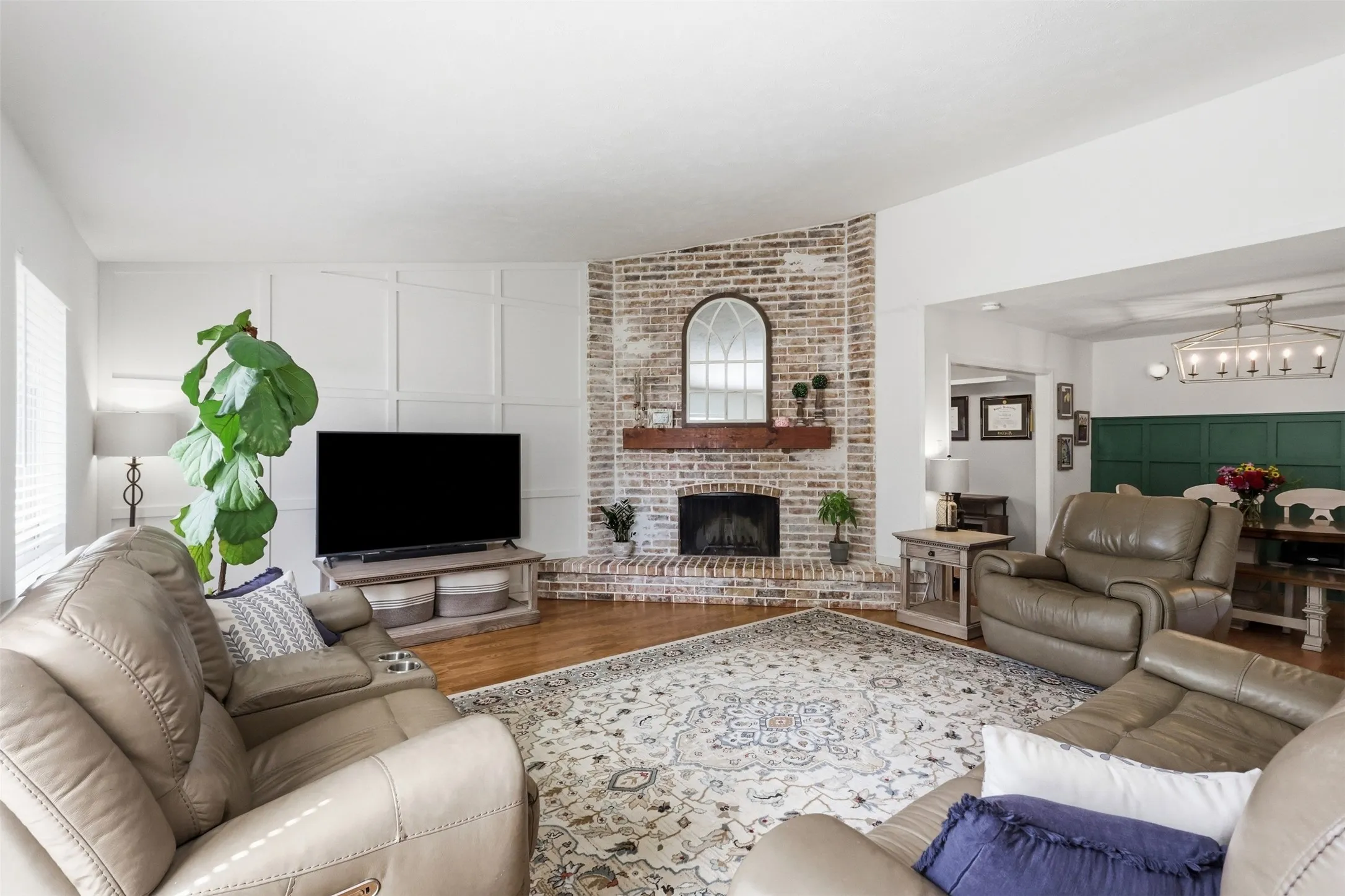 Bright and open living space with large windows and a warm, comfortable layout.