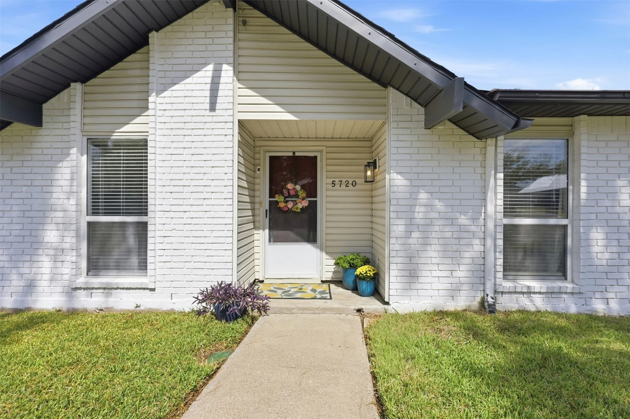 Welcoming covered front entry with clean curb appeal and an inviting approach.