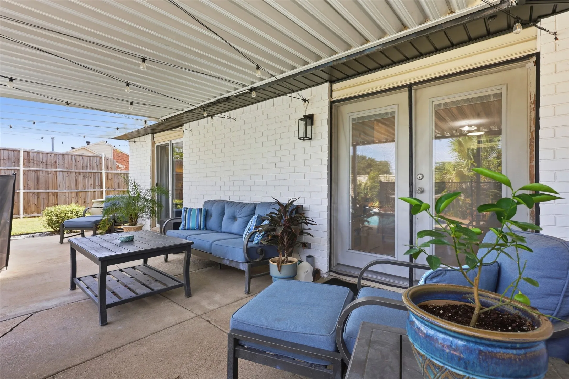 Another view of the patio showing the easy indoor-outdoor connection and poolside setting.