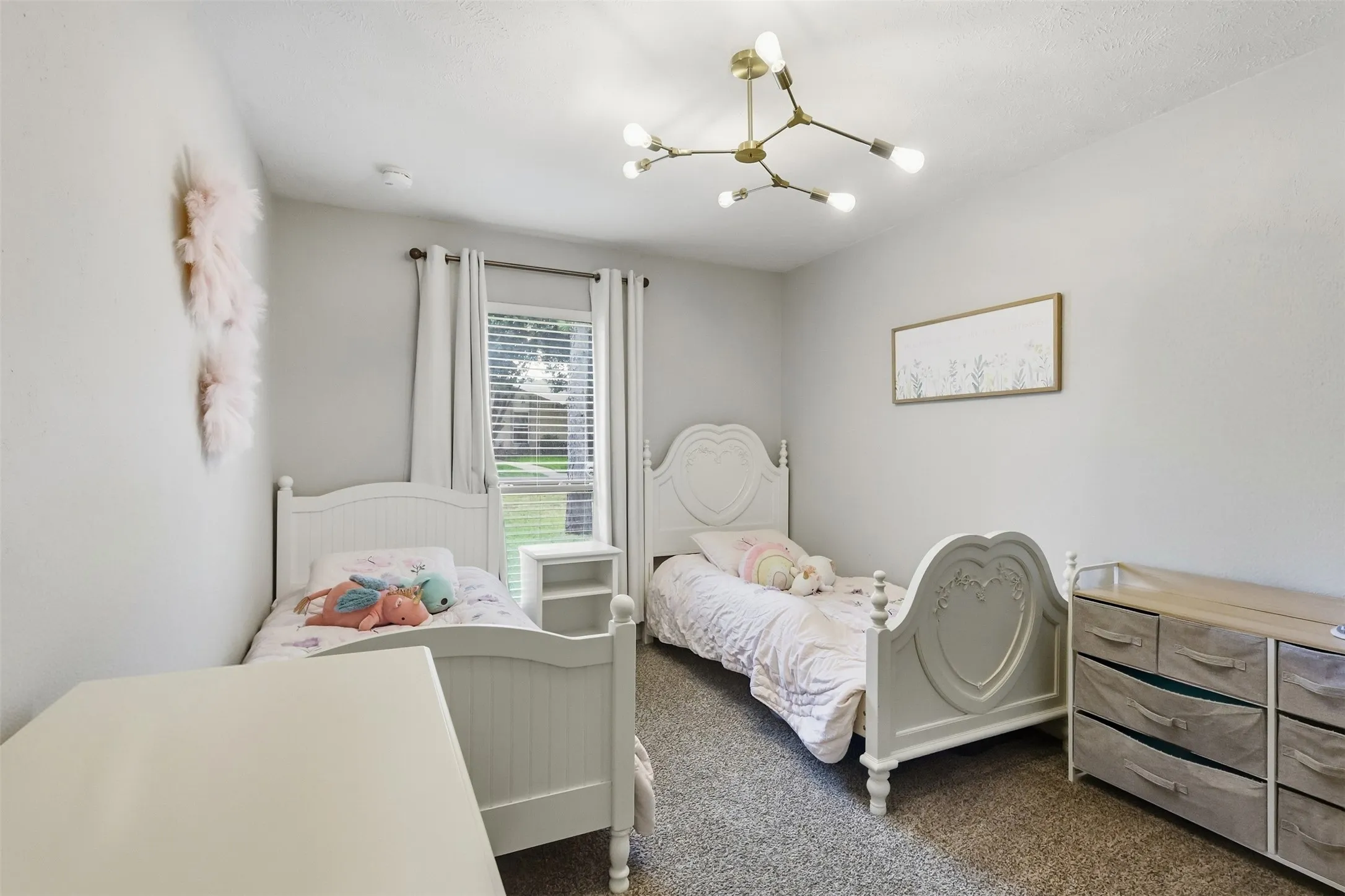 Light-filled secondary bedroom with neutral tones and flexible use for guests, kids, or a home office.