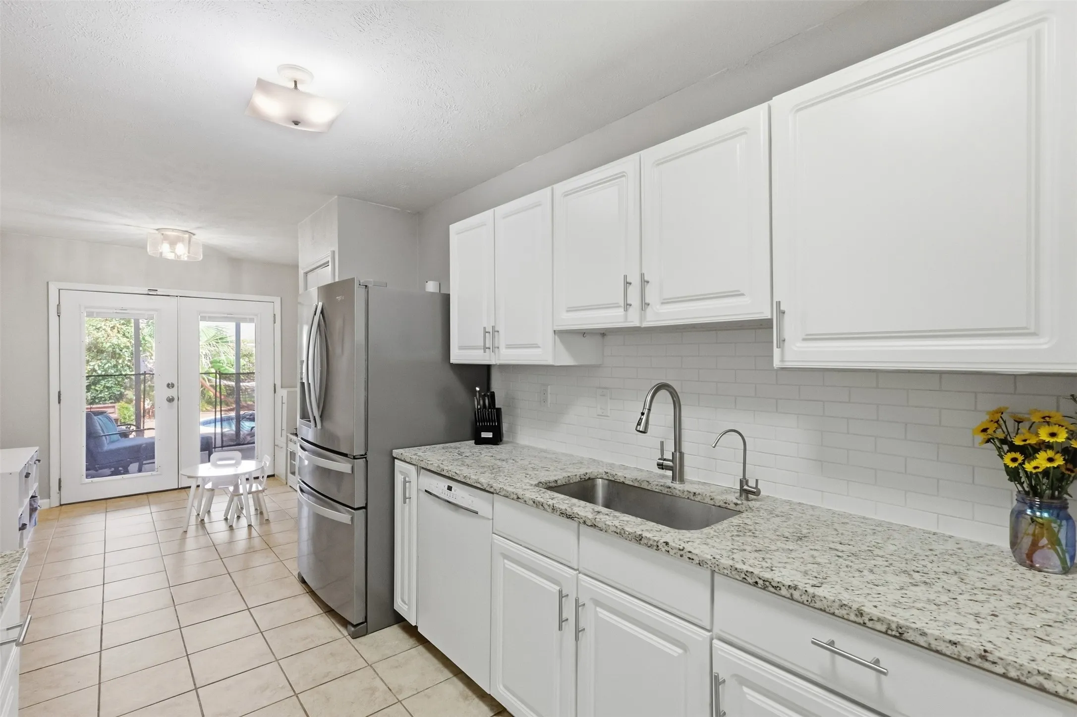 Light-filled kitchen with ample counter space and a clean, neutral finish.