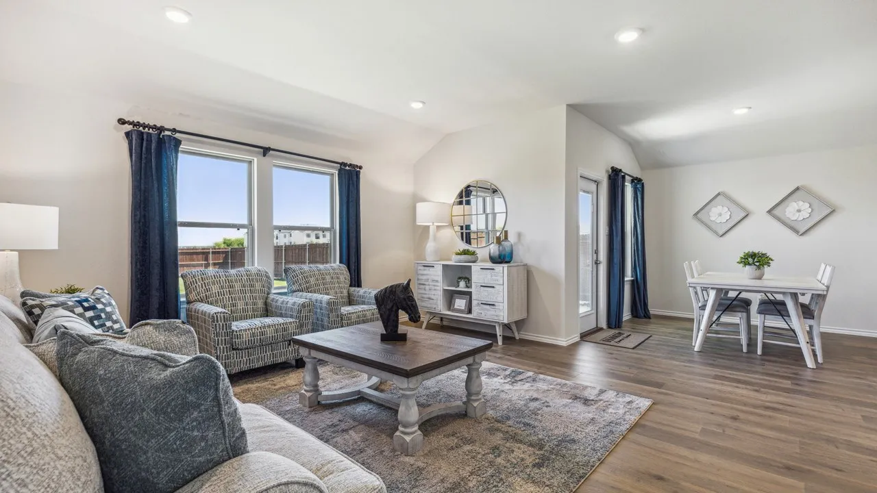 Living room featuring dark wood-style flooring, lofted ceiling, and recessed lighting