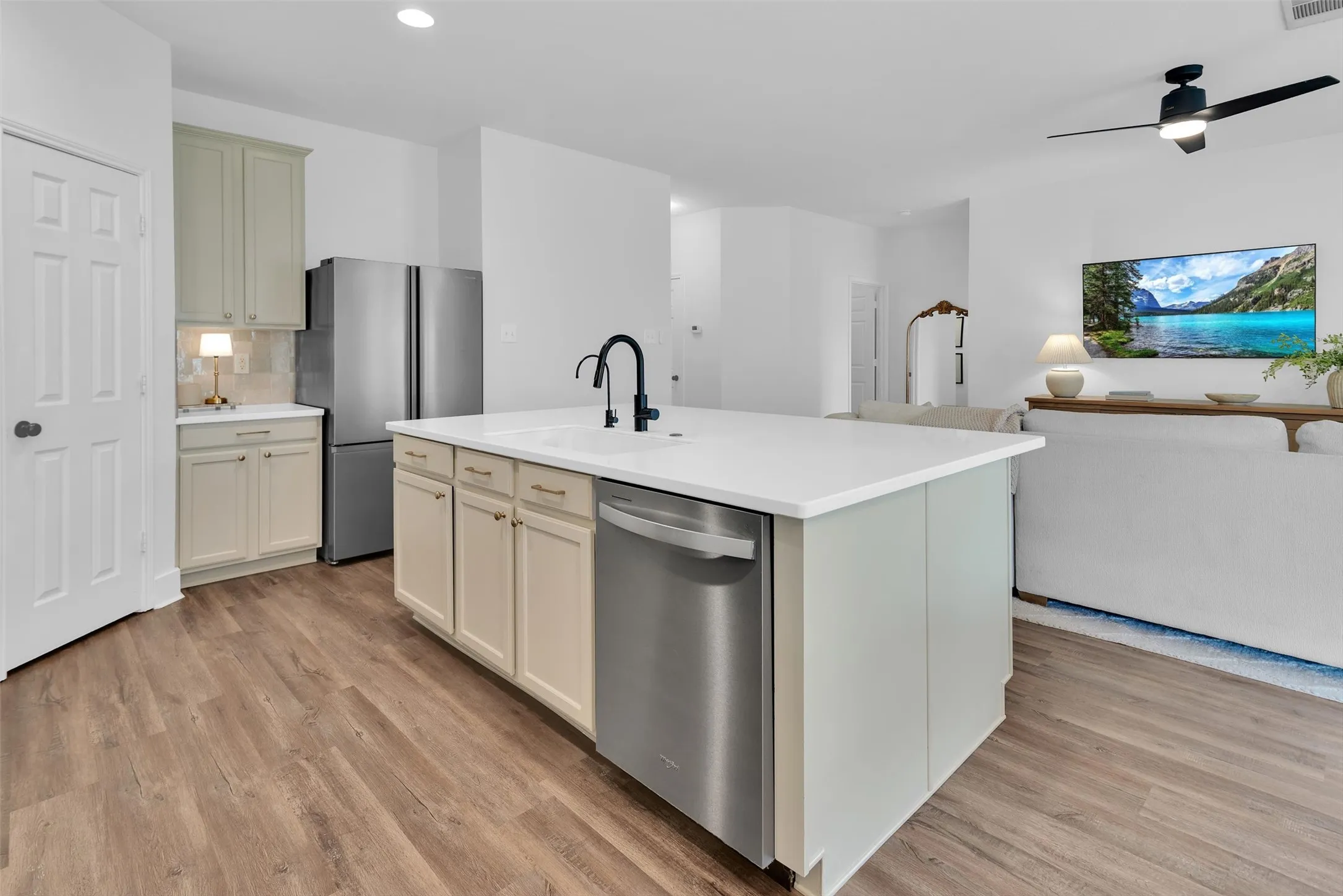 Kitchen island with an undermount sink, gooseneck faucet, and integrated dishwasher