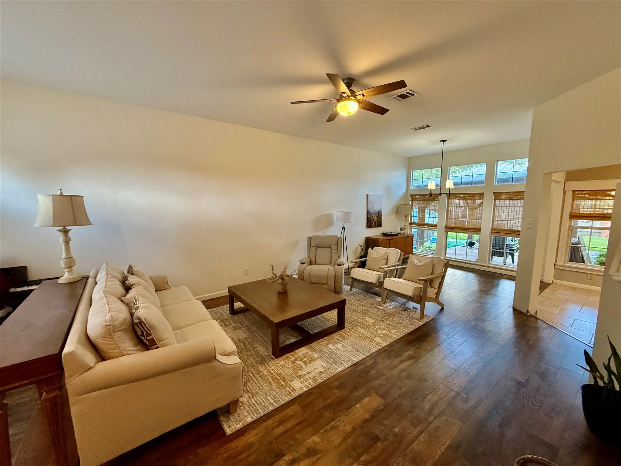 High ceilings, wood-finish flooring, ceiling fan with integrated lighting, multiple transom windows, and recessed​​‌​​​​‌​​‌‌​‌‌​​​‌‌​‌​‌​‌​​​‌​​ lighting