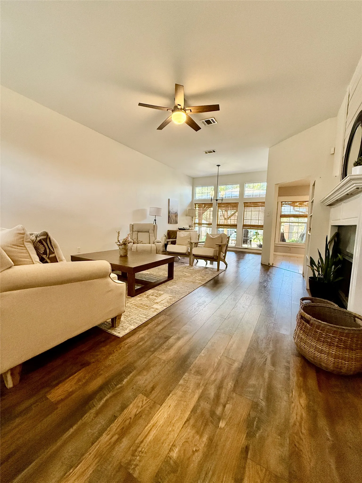 Wood-finish flooring throughout, complemented by a vaulted ceiling with a ceiling fan