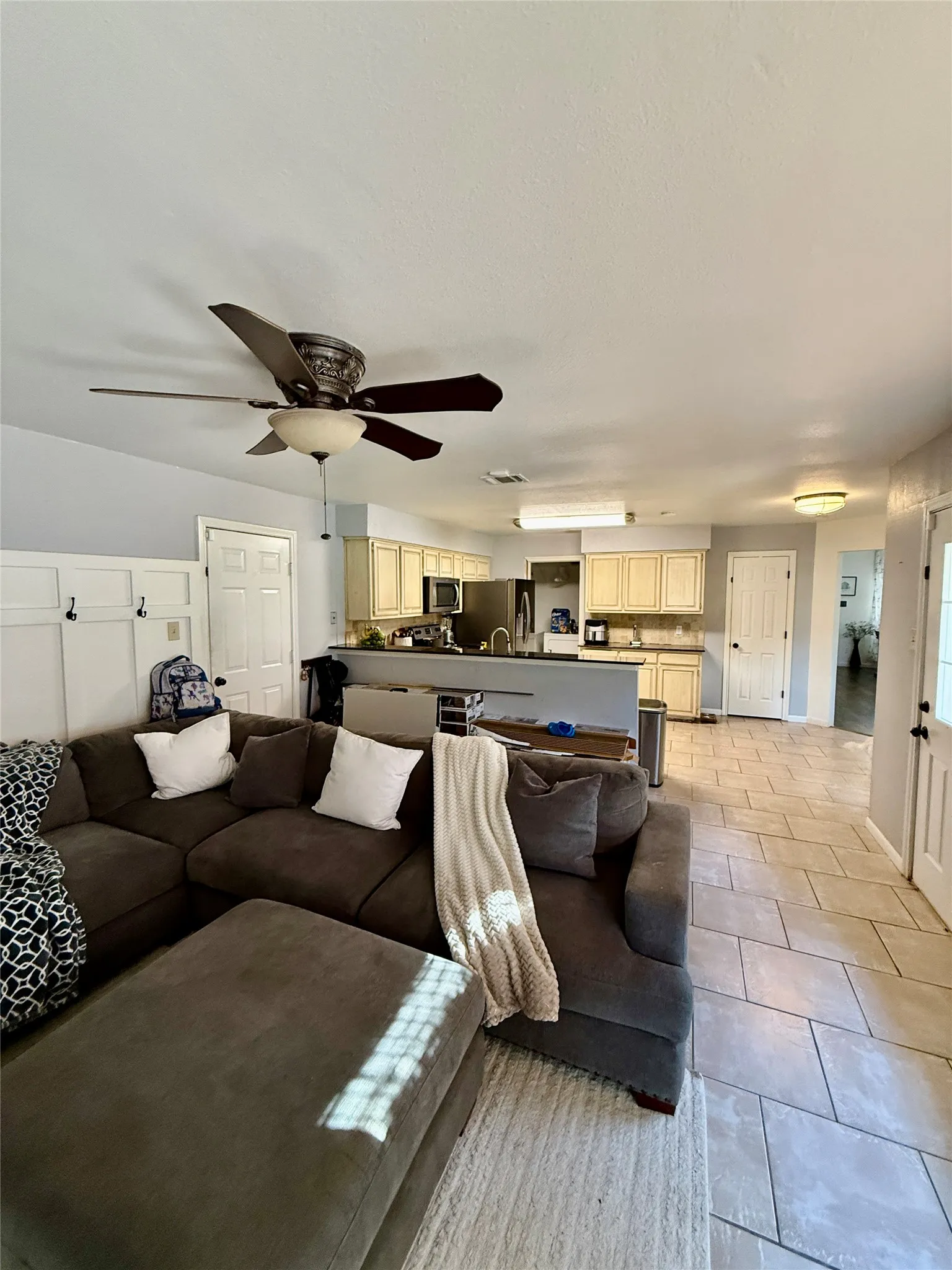 Kitchen featuring light cabinetry, stainless steel appliances, and a breakfast bar