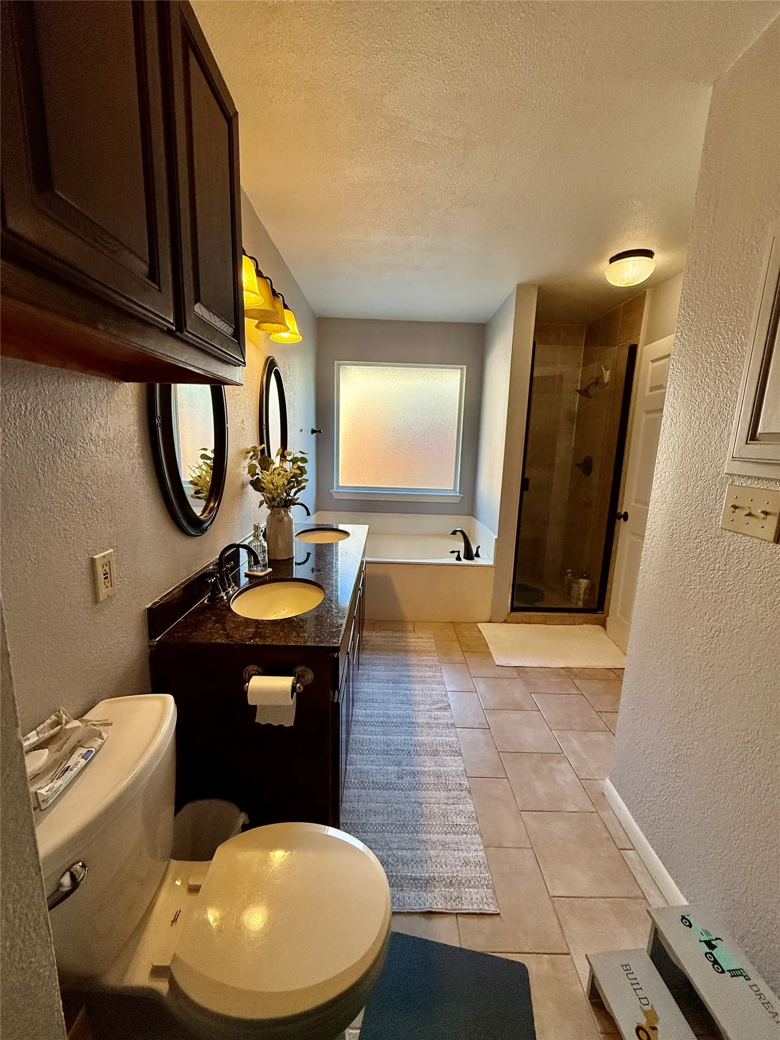 Dual vanity with undermount sinks and dark stone countertop
