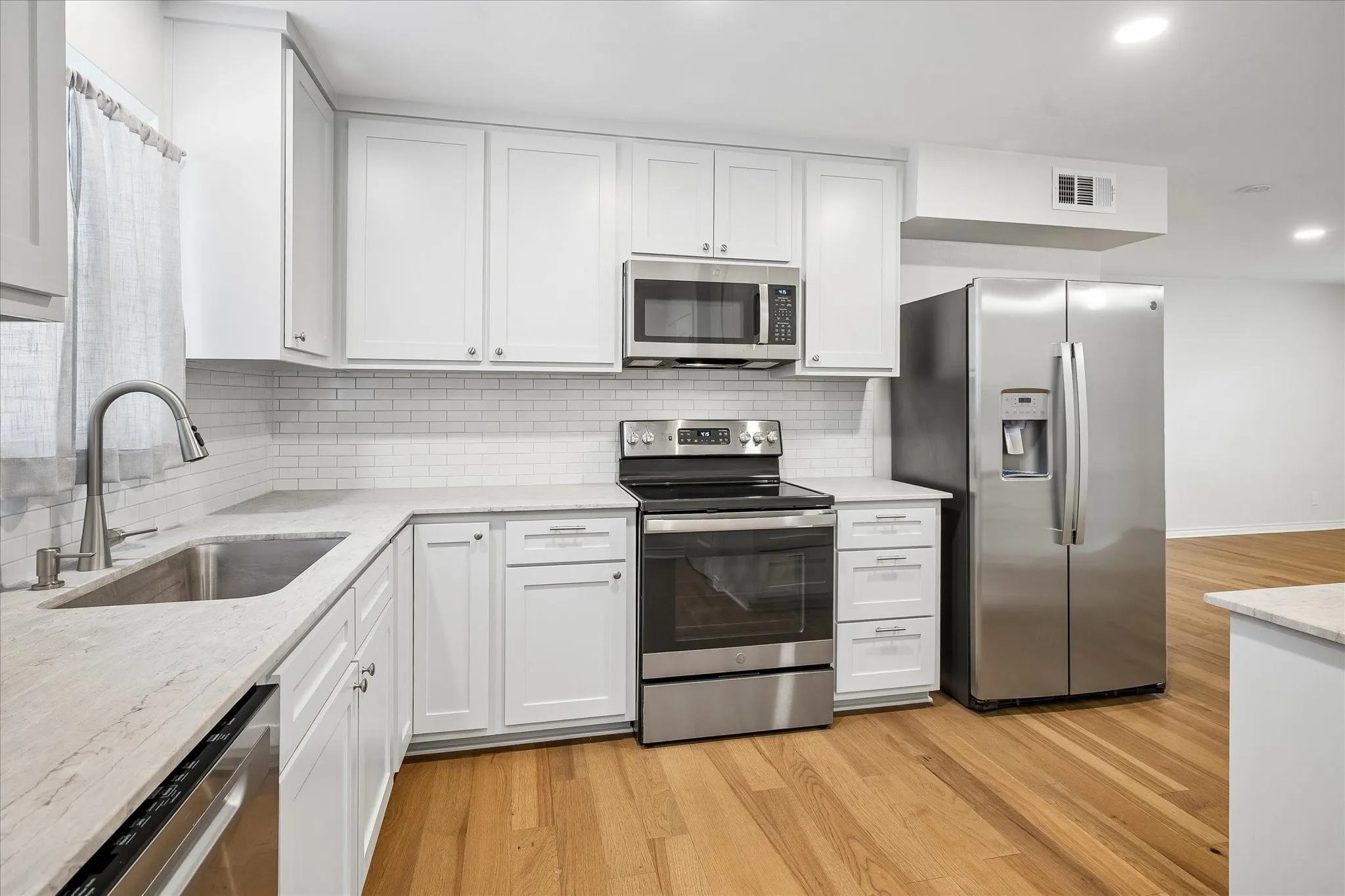 Well Lit Kitchen With Granite/Granite Type Counters