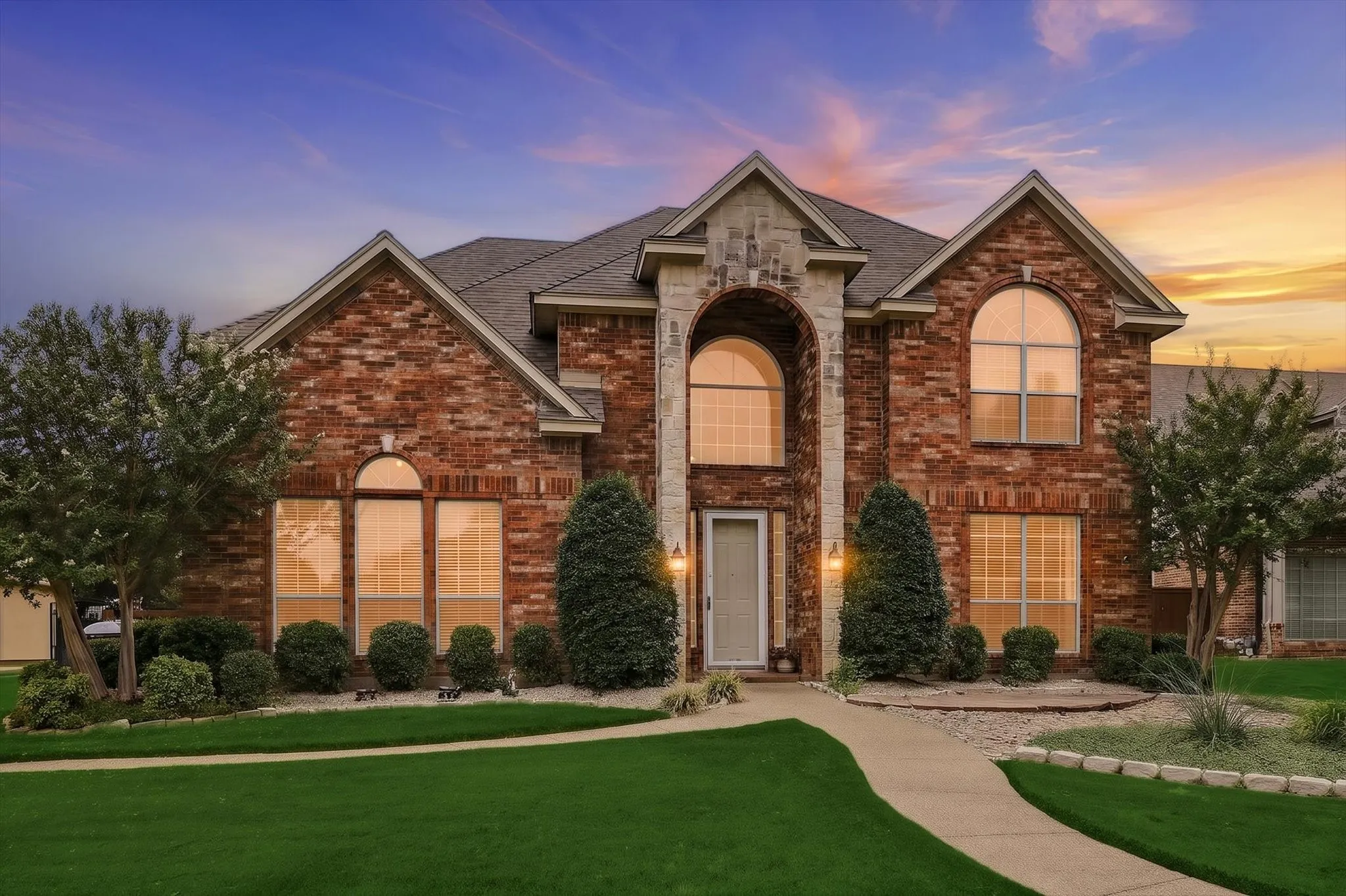 Striking brick exterior with arched entryways and stone accents showcases classic architectural detail
