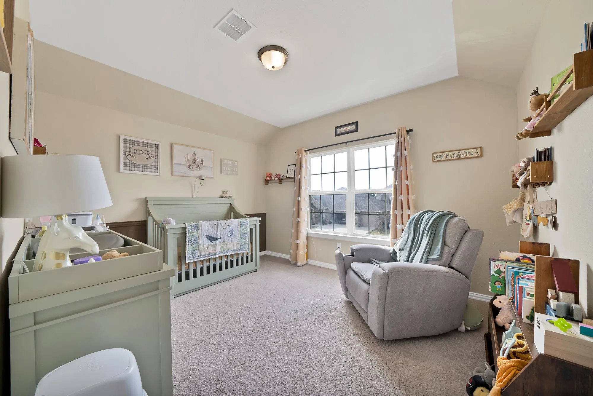 Vaulted ceiling, recessed lighting, carpet flooring, window with exterior landscaping, wall-mounted shelving