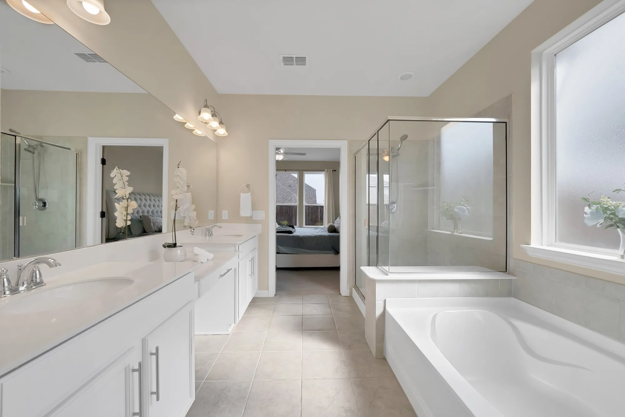 Dual vanity with white cabinetry and chrome fixtures