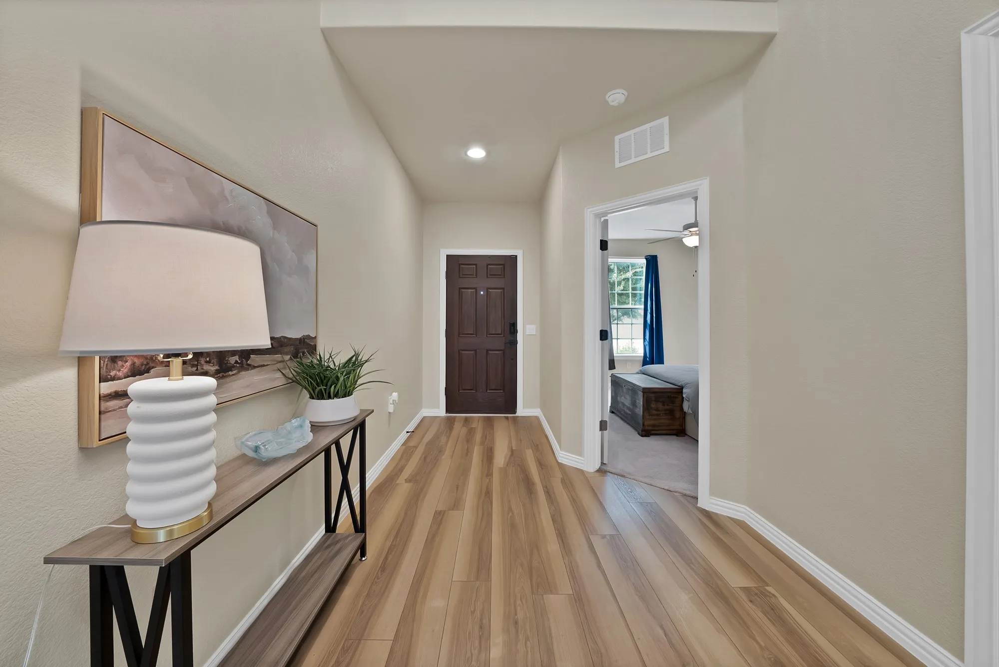 Wood-finish flooring throughout the hallway