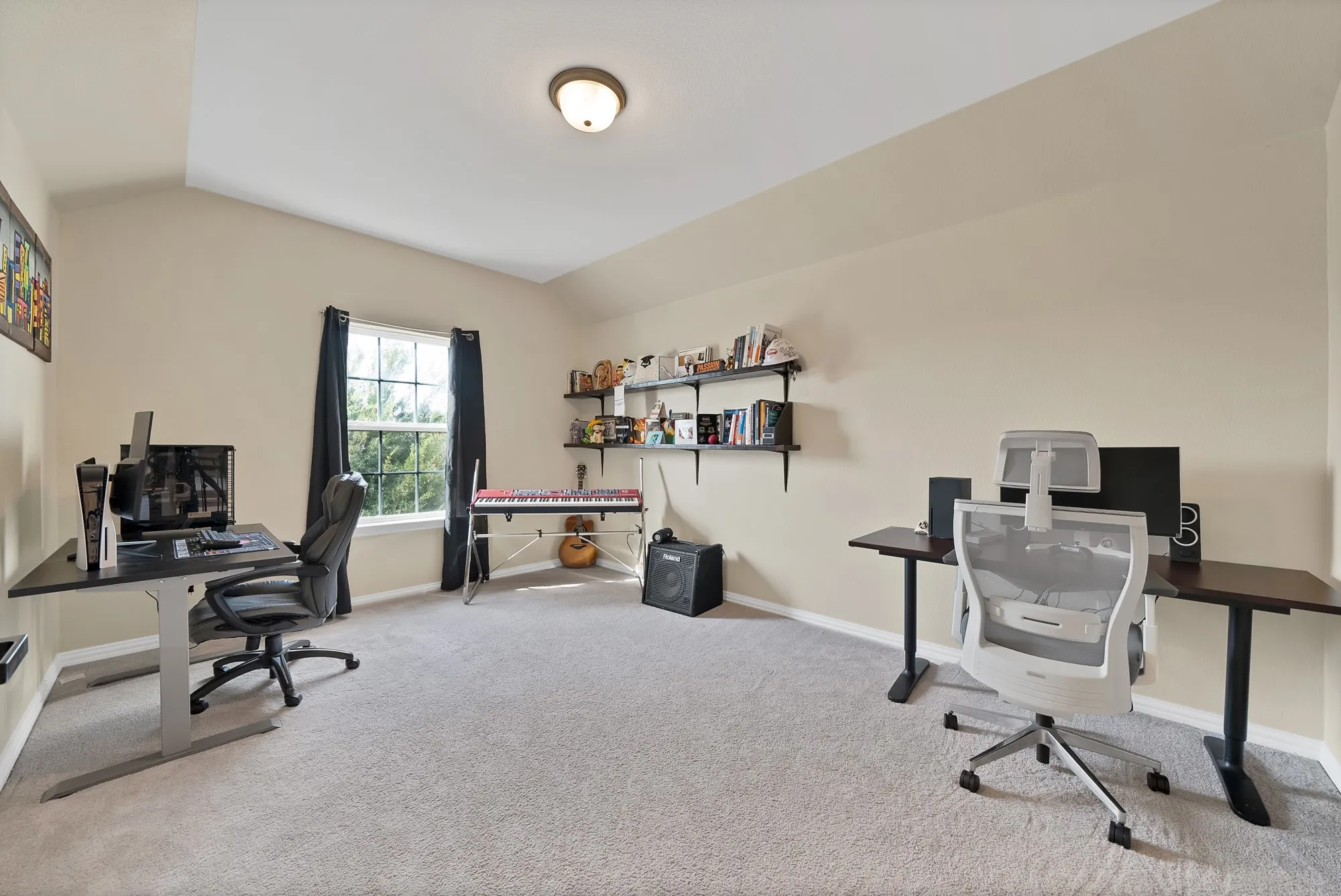 Recessed lighting, sloped ceiling, light-toned carpeting, and a window with natural light
